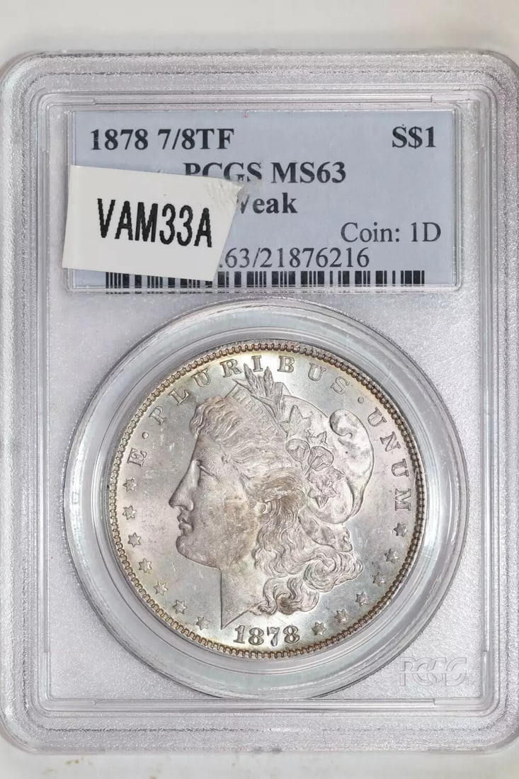 FLASHY PQ - 1878 7/ 8TF VAM-33A MORGAN DOLLAR PCGS MS63: FLASHY PQ - 1878 7/ 8TF VAM-33A MORGAN DOLLAR PCGS MS63 Experience the majesty of American numismatics with this stunning 1878 Morgan Dollar, graded MS63 by PCGS and certified as VAM-33A. Its uncircul