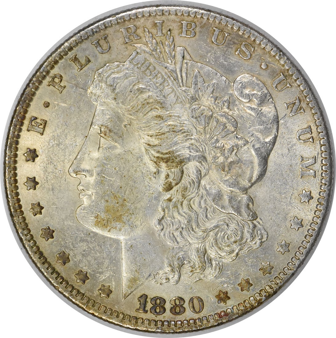 1880-O Morgan Silver Dollar - AU Slider, Uncertified: 1880-O Morgan Silver Dollar - AU Slider, Uncertified Experience the elegance of the 1880-O Morgan Silver Dollar, a rare and highly sought-after coin from the United States Mint in New Orleans. With it
