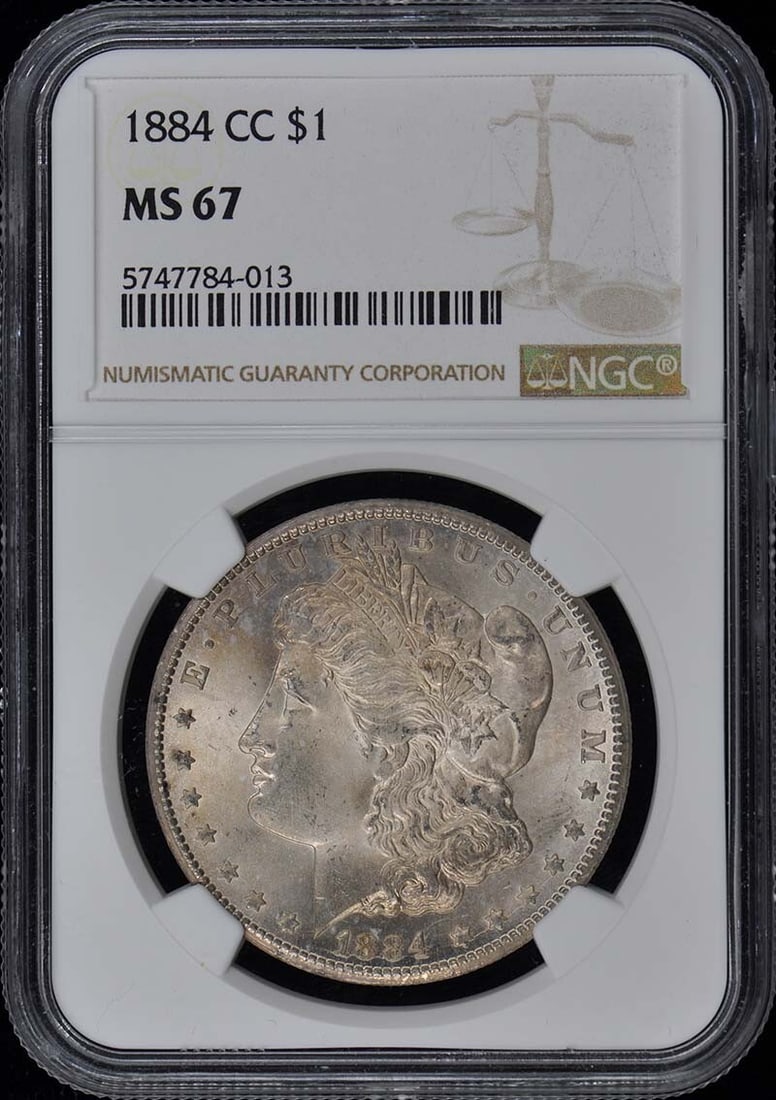 MS67 1884-CC Morgan Dollar S$1 NGC: MS67 1884-CC Morgan Dollar S$1 NGC Experience the majesty of American numismatics with this stunning MS67 1884-CC Morgan Dollar, certified by NGC and boasting an impressive grade of 67. As one of the