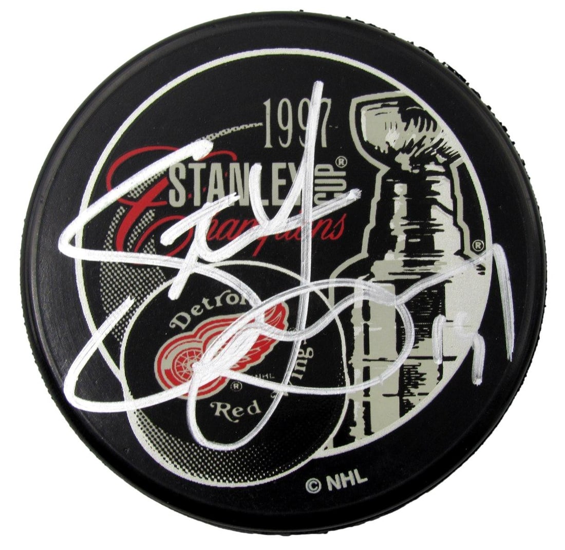 Steve Yzerman HOF Signed 1997 Stanley Cup Red Wings Hockey Puck (PSA/ DNA 927): Steve Yzerman HOF Signed 1997 Stanley Cup Red Wings Hockey Puck (PSA/ DNA 927) Own a piece of Detroit Red Wings history with this autographed 1997 Stanley Cup puck, signed by the legendary Steve Yzerm