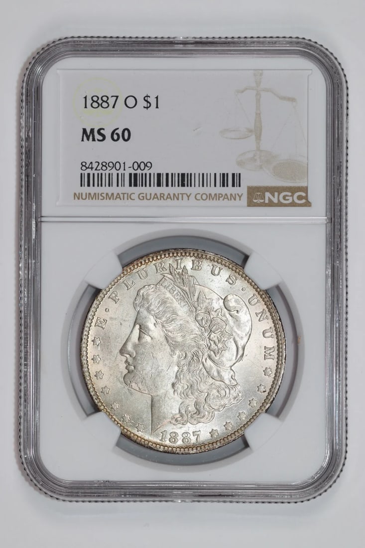 1887-O Morgan Dollar NGC MS60: 1887-O Morgan Dollar NGC MS60 Experience the beauty of the 1887-O Morgan Dollar, a rare and highly sought-after coin from the iconic New Orleans mint. With its MS60 grade from the Numismatic Guaranty