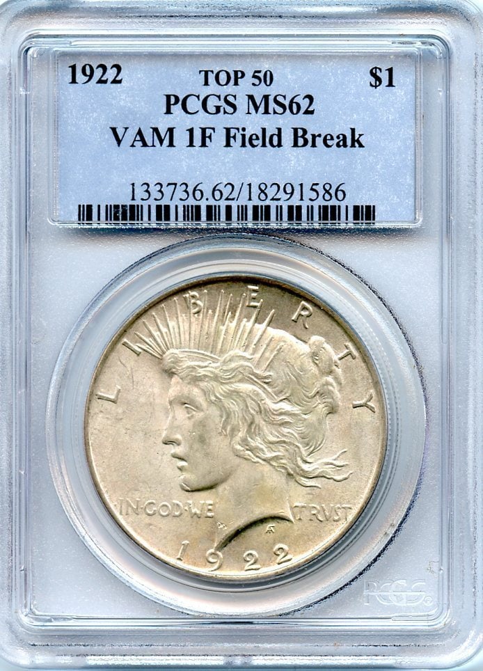 1922 VAM-1F "Field Break" Peace Dollar PCGS MS62: 1922 VAM-1F "Field Break" Peace Dollar PCGS MS62 Experience the rare beauty of the 1922 VAM-1F "Field Break" Peace Dollar, certified MS62 by PCGS. This highly sought-after error coin boasts a striking