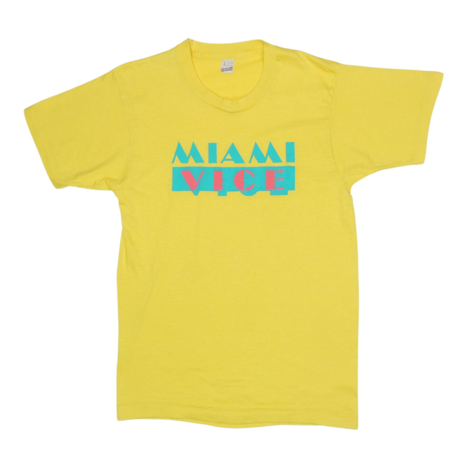 Shirt 1980s Miami Vice: Shirt 1980s Miami Vice Get ready to channel your inner Crockett and Tubbs in this authentic 1980s Miami Vice shirt, featuring a vibrant yellow color and classic 50/50 poly/cotton construction. With it