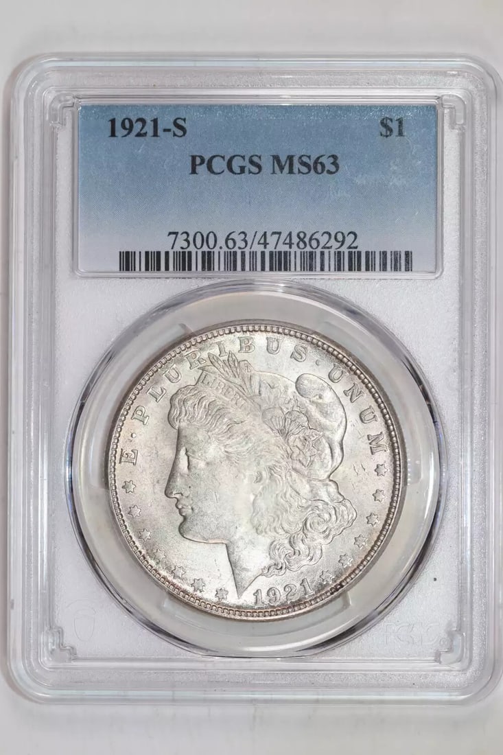 1921-S Morgan Dollar PCGS MS63: 1921-S Morgan Dollar PCGS MS63 Experience the beauty of a bygone era with this stunning 1921-S Morgan Dollar, certified MS63 by PCGS. Struck in silver and bearing the iconic San Francisco mint mark, t