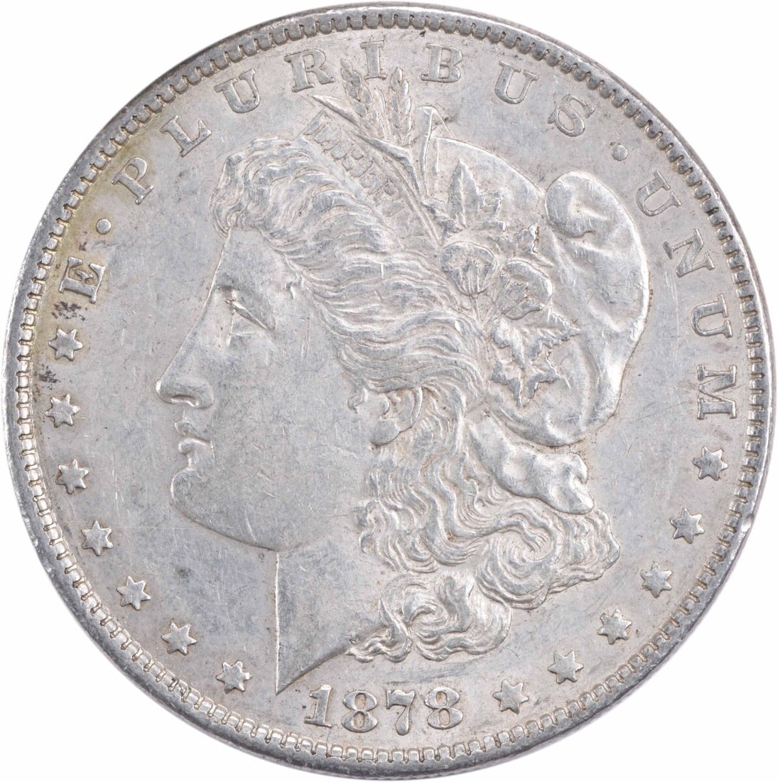 1878 Morgan Silver Dollar - 7TF Reverse, 1879 AU Uncertified: 1878 Morgan Silver Dollar - 7TF Reverse, 1879 AU Uncertified A rare and highly sought-after 1878 Morgan Silver Dollar, graded AU Uncertified, boasts its original 7TF reverse, a hallmark of the series'