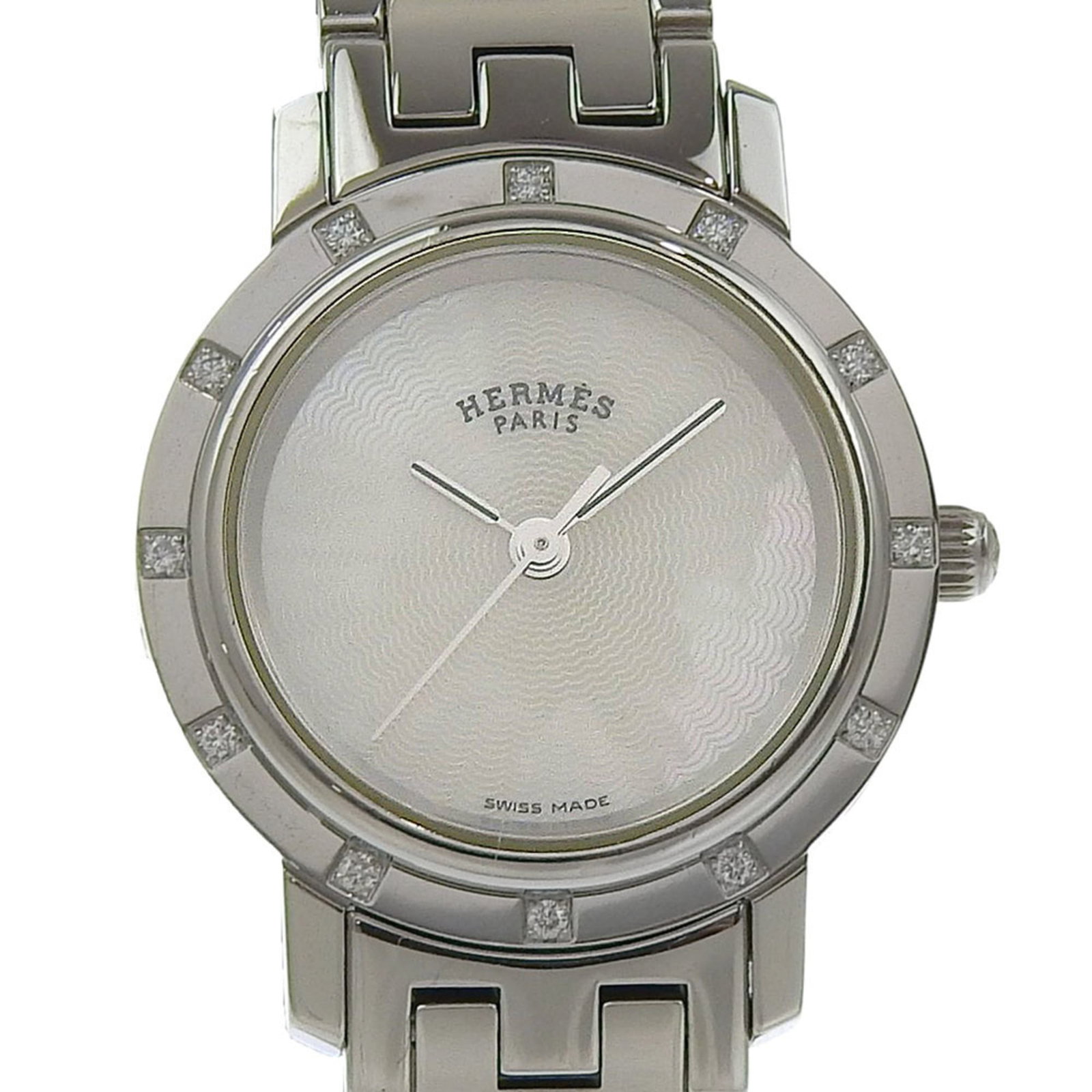 Wristwatch Hermes: Wristwatch Hermes A pre-owned Hermes wristwatch, perfect for the discerning woman, boasts a sleek stainless steel case and band, paired with a crisp white dial that exudes elegance. With its 29mm diam