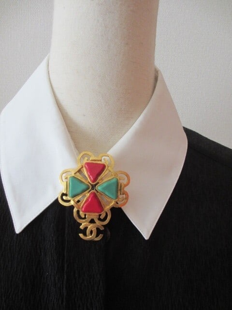 Vintage Chanel 95P Coco Mark CC Gripoix Pin Brooch: Vintage Chanel 95P Coco Mark CC Gripoix Pin Brooch A stunning vintage Chanel brooch, this 95P Coco Mark CC Gripoix pin boasts a rich gold tone and striking red-green Gripoix stone, evoking the opulenc