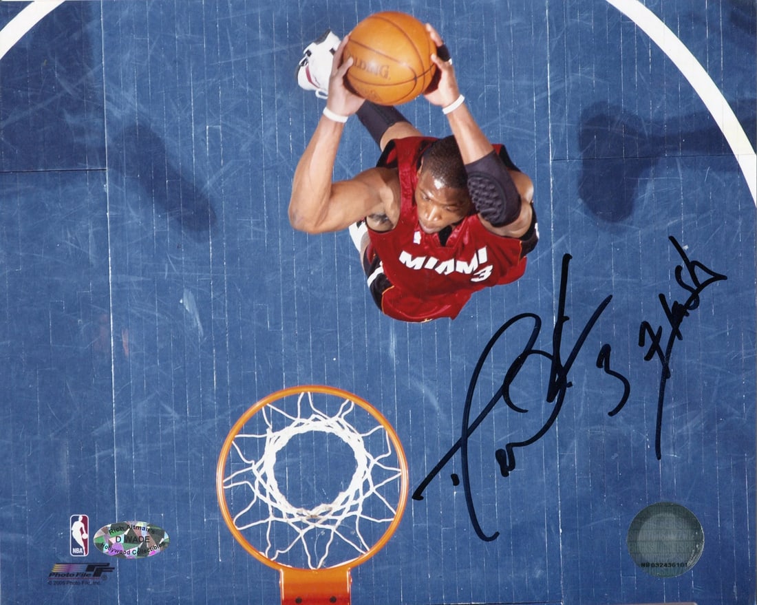 Dwyane Wade Autographed 8x10 "Flash" Dunking Photo: Dwyane Wade Autographed 8x10 "Flash" Dunking Photo Get ready to relive the highlight-reel moments of Dwyane Wade's illustrious career with this authentic 8x10 photo, signed in black sharpie by the leg