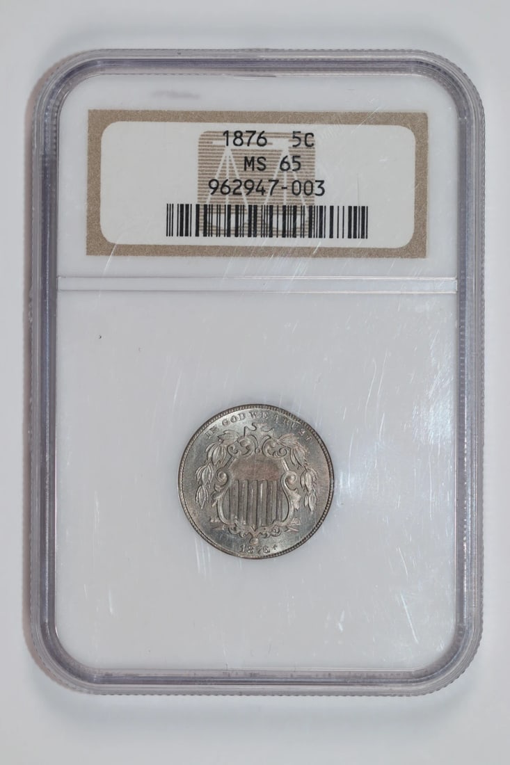 1876 Shield Nickel NGC MS65: 1876 Shield Nickel NGC MS65 Experience the rich history of the United States with this stunning 1876 Shield Nickel, certified by the Numismatic Guaranty Corporation (NGC) as MS65. This uncirculated co