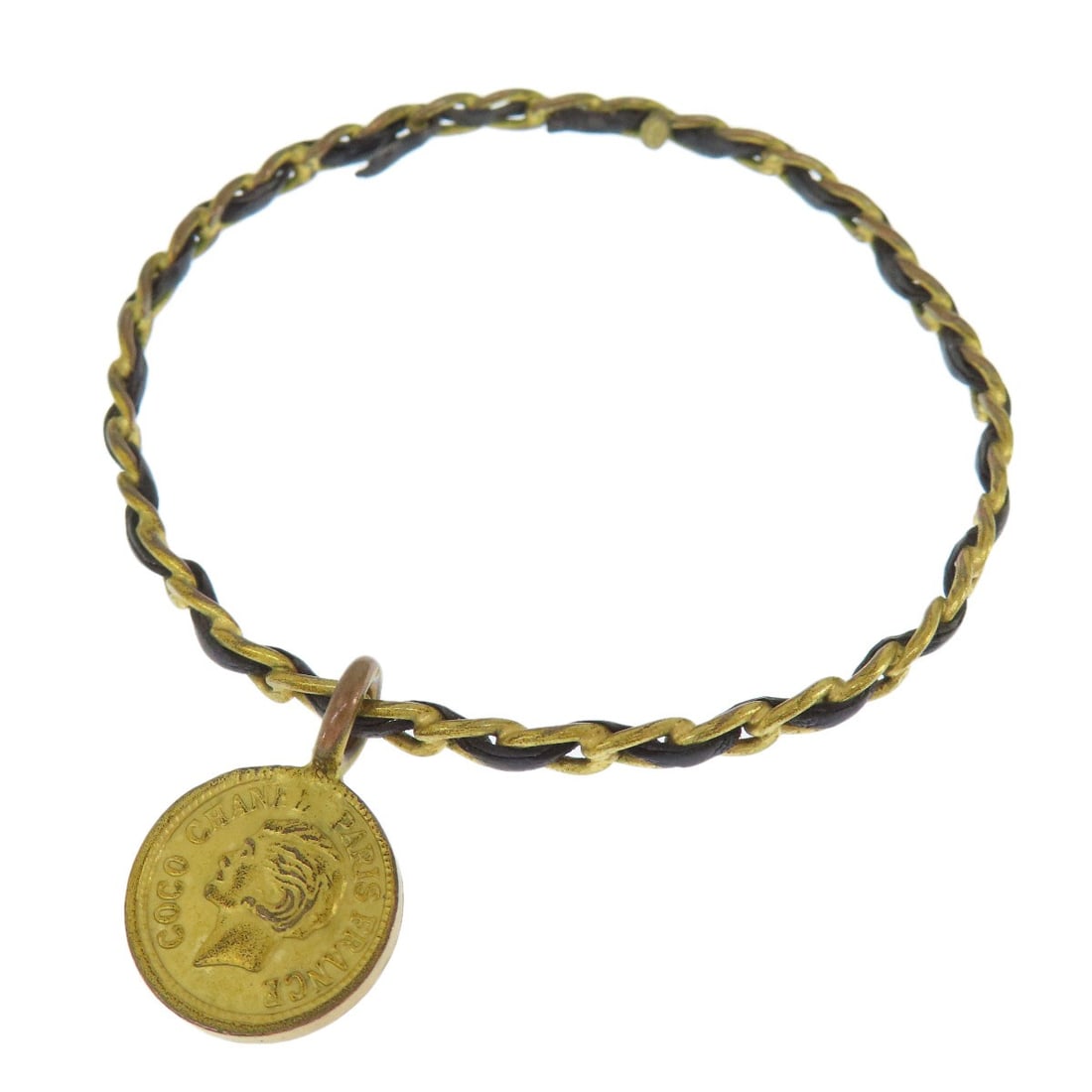 Coco Chanel Mark Bangle Metal Leather: Coco Chanel Mark Bangle Metal Leather Elevate your style with the iconic Coco Chanel Mark bangle, crafted from luxurious metal and sleek black leather. This timeless French design boasts a striking