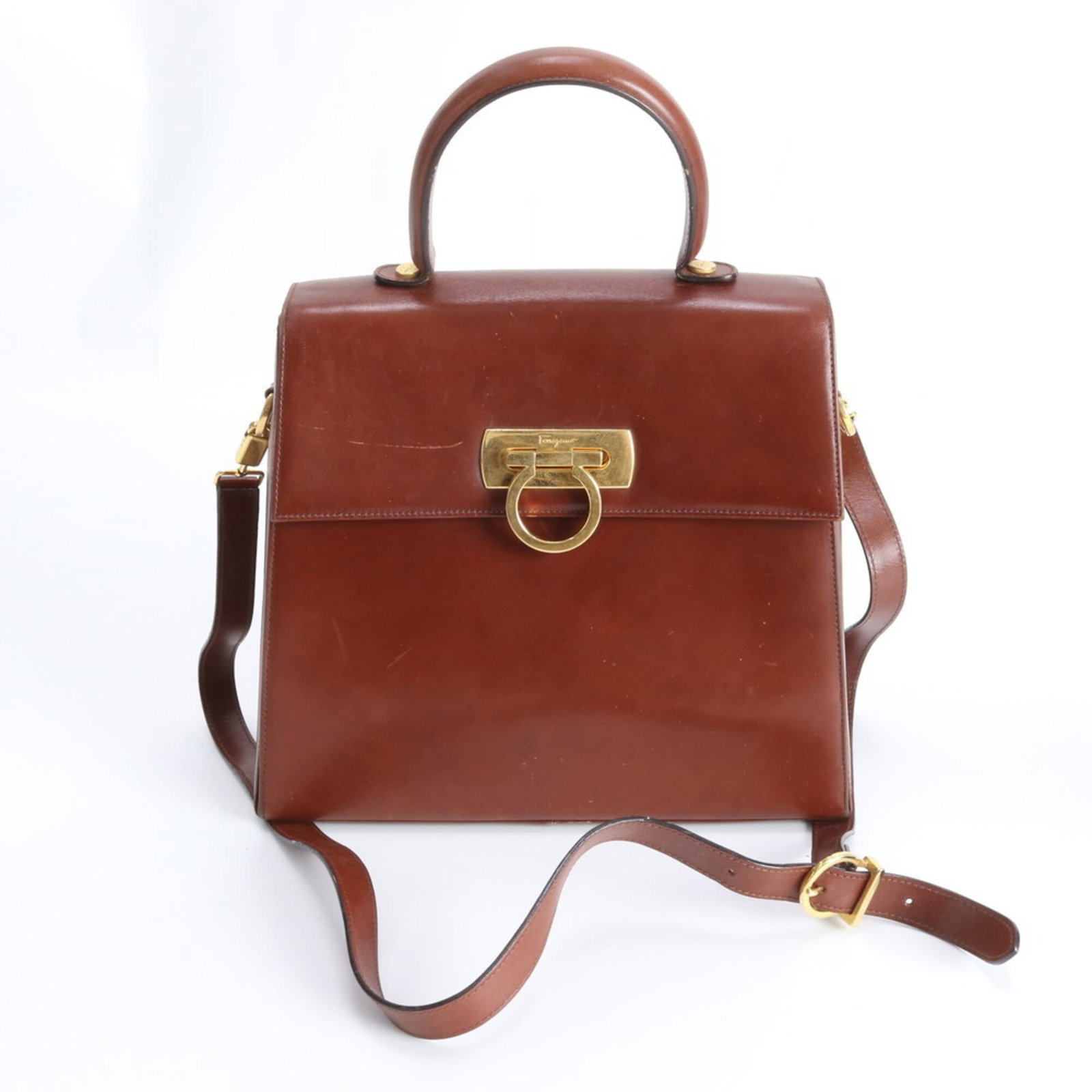 Ferragamo Leather Shoulder Bag: Ferragamo Leather Shoulder Bag A timeless classic, this Salvatore Ferragamo leather shoulder bag boasts rich brown tones and supple leather that develops a beautiful patina with age. With its