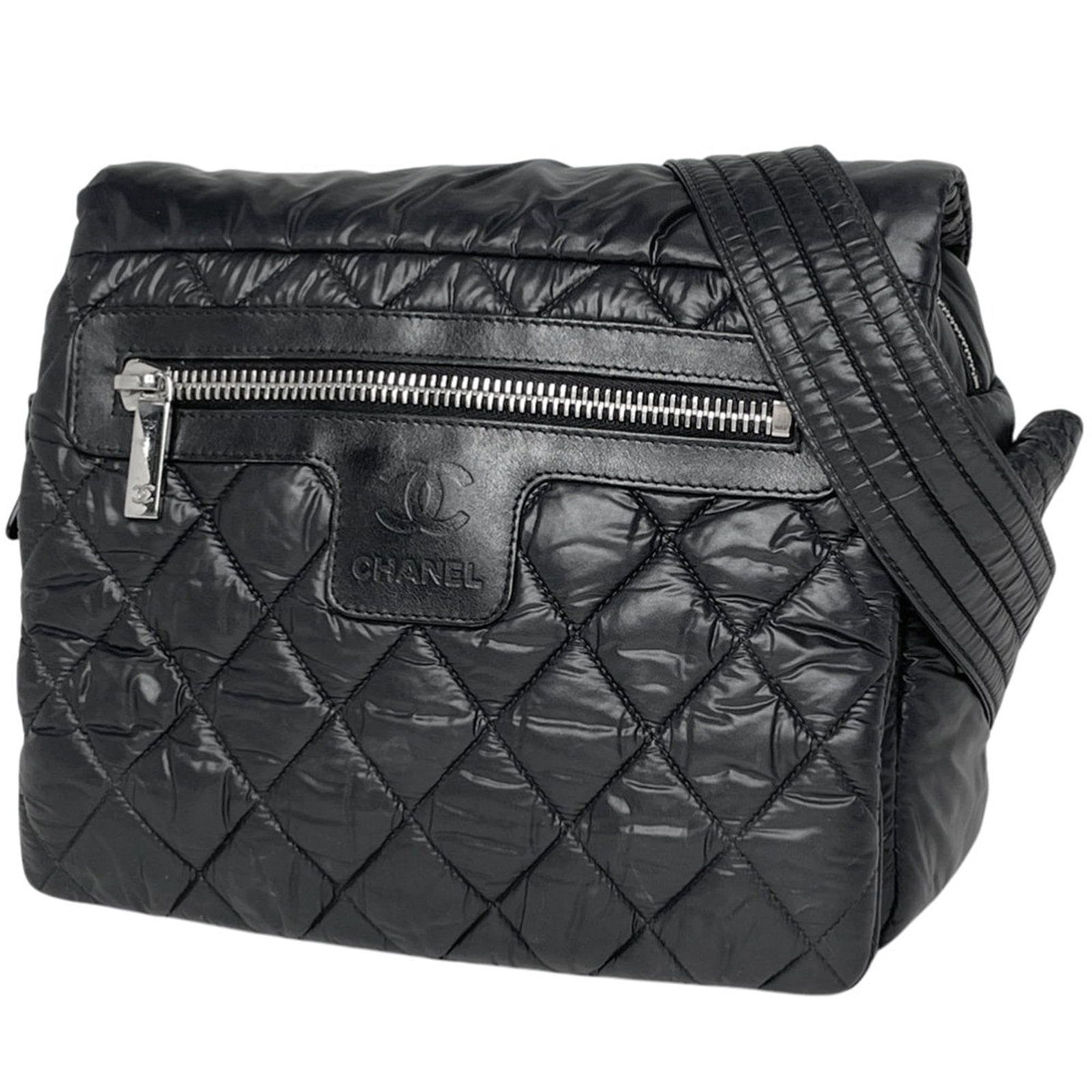 Chanel Leather Nylon Shoulder Bag: Chanel Leather Nylon Shoulder Bag A chic and versatile Chanel shoulder bag, crafted from luxurious leather and durable nylon, is up for grabs in this stunning black piece. With its sleek 20cm x 24cm s