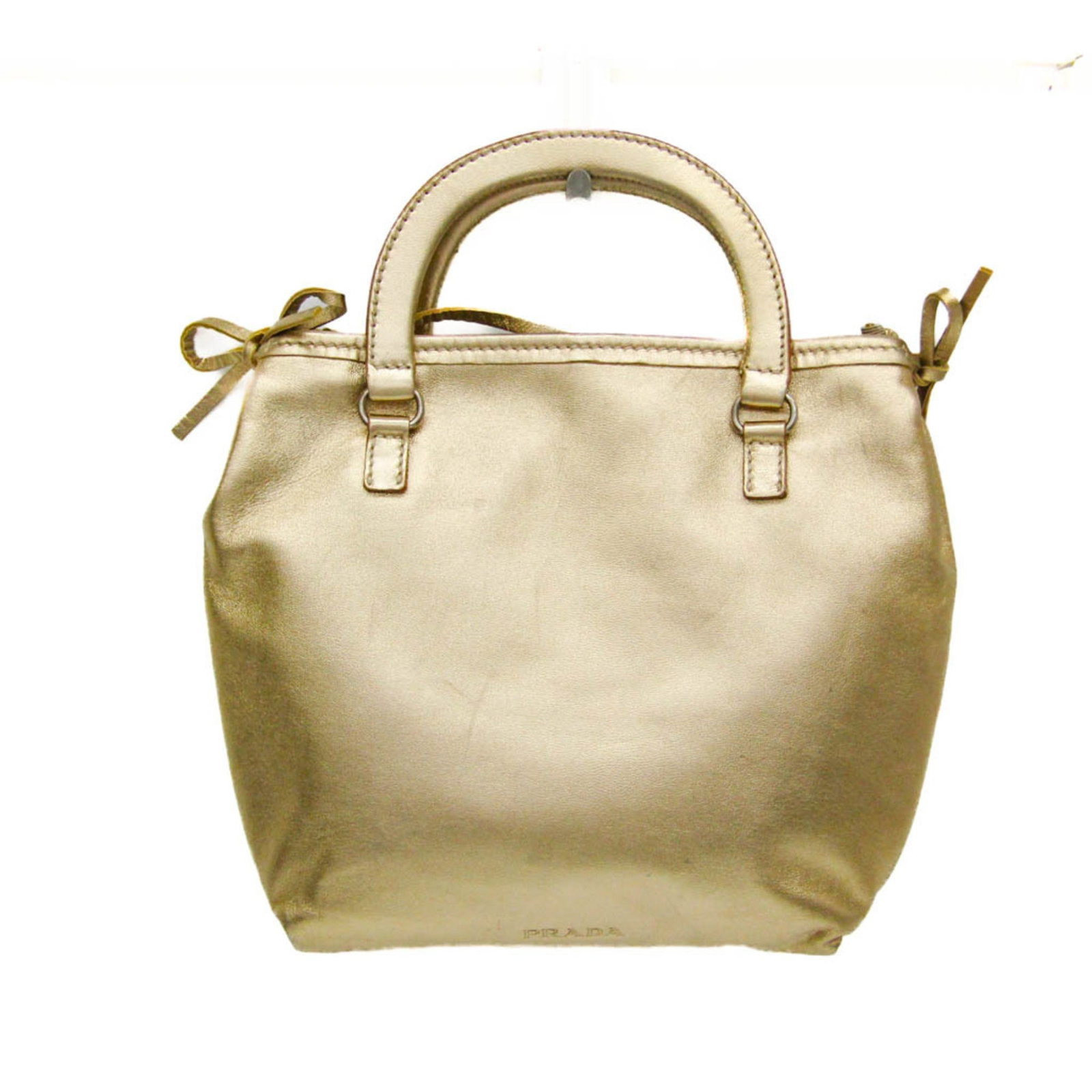 Prada leather shoulder bag: Prada leather shoulder bag Elevate your style with this luxurious Prada leather shoulder bag, boasting sleek gold hardware and a classic design that exudes sophistication. The spacious interior is