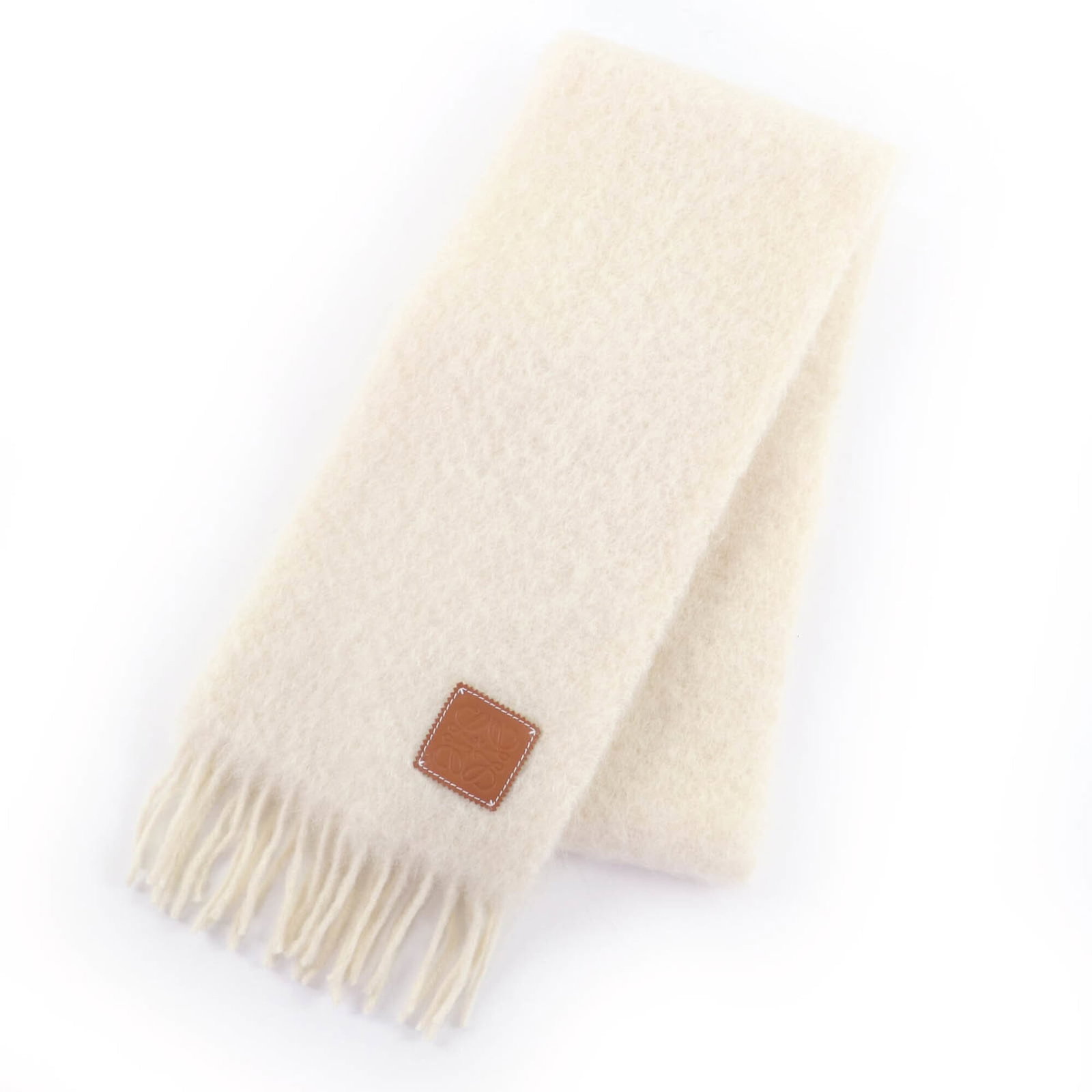 Loewe Shawl Mohair, Wool, Nylon: Loewe Shawl Mohair, Wool, Nylon This stunning Loewe shawl is crafted from a luxurious blend of mohair, wool, and nylon, making it both durable and stylish. Its classic design and soft ivory hue evoke