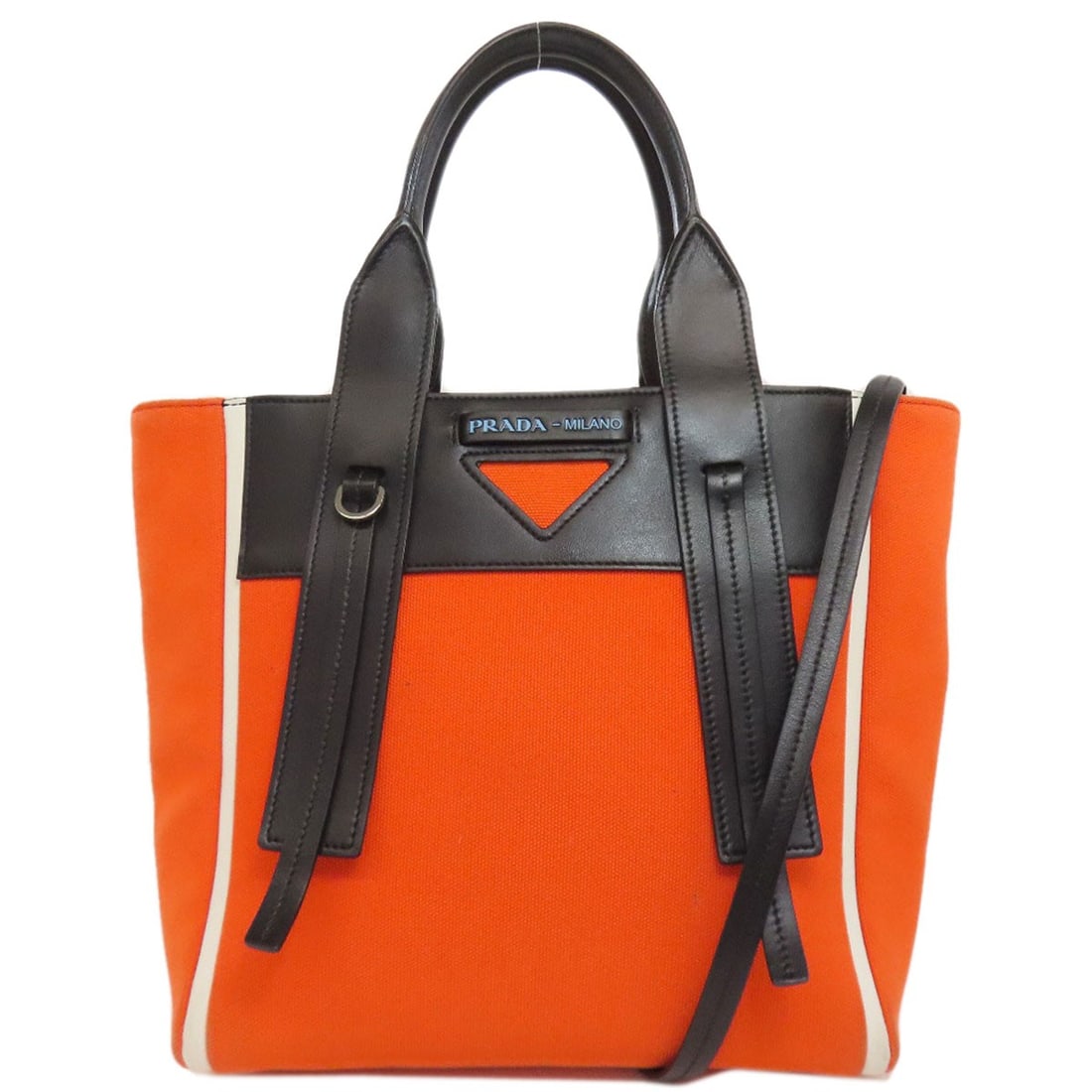 Canvas leather handbag Prada Ouverture: Canvas leather handbag Prada Ouverture The iconic Prada Ouverture handbag boasts a striking canvas leather exterior in vibrant orange and black hues, exuding a bold and sophisticated style that's