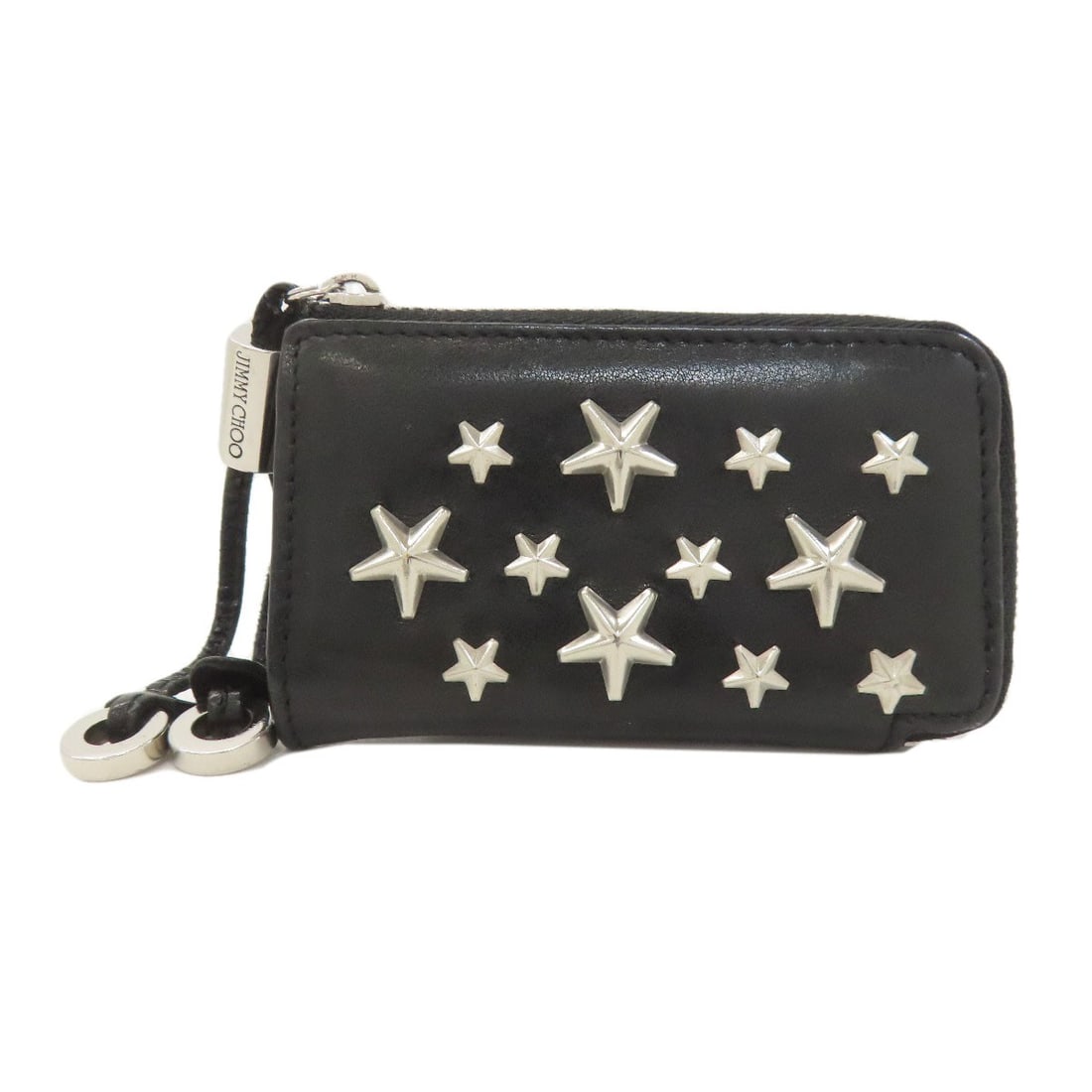 Leather Jimmy Choo coin purse with star motif.: Leather Jimmy Choo coin purse with star motif. Elevate your everyday style with this sleek leather coin purse from Jimmy Choo, boasting a striking star motif that adds a touch of glamour to any outfit