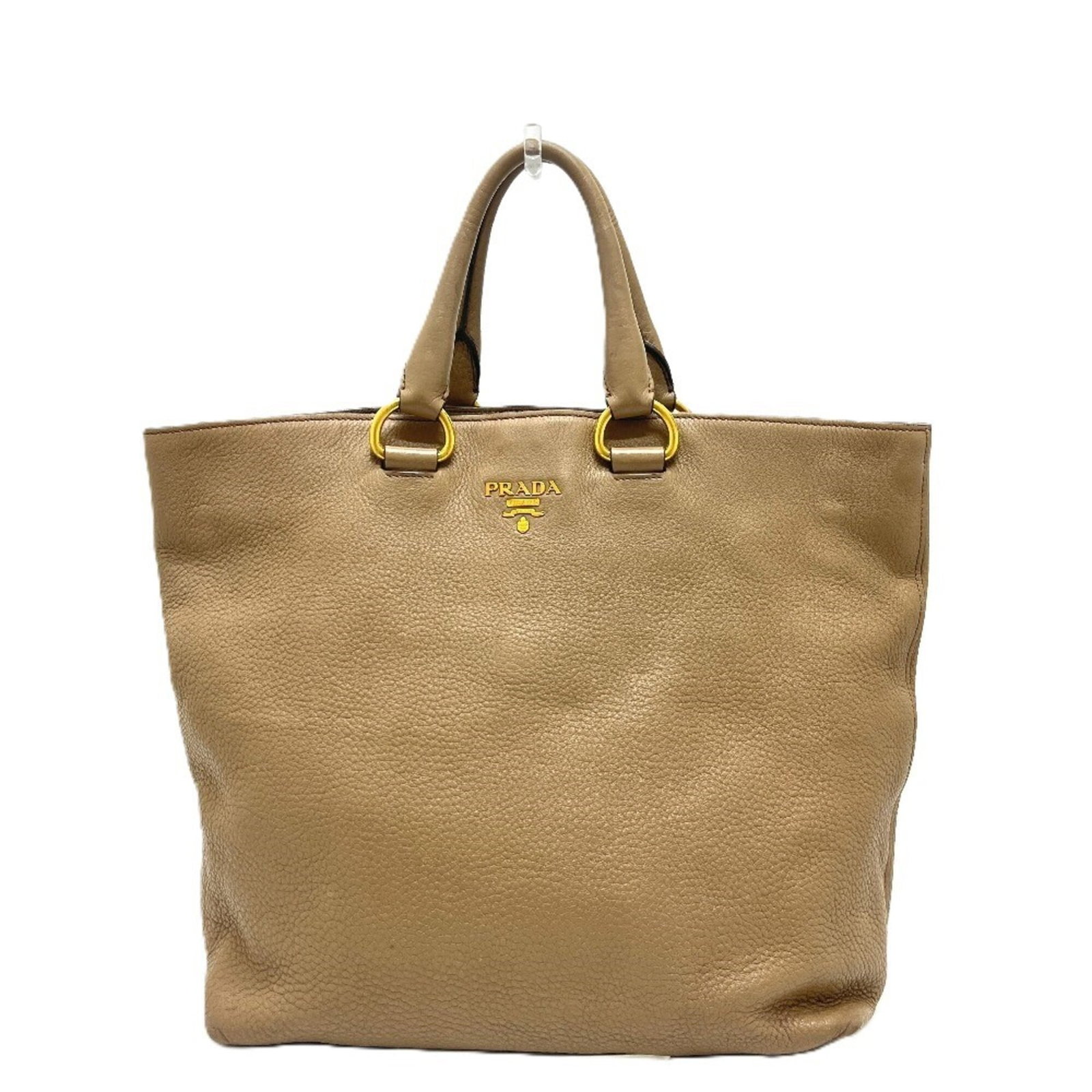 Prada Handbag Nylon Leather Tote: Prada Handbag Nylon Leather Tote A stylish and practical Prada tote, made from a combination of durable nylon and supple leather, is up for grabs in this beautiful beige beaded bag. With its classic