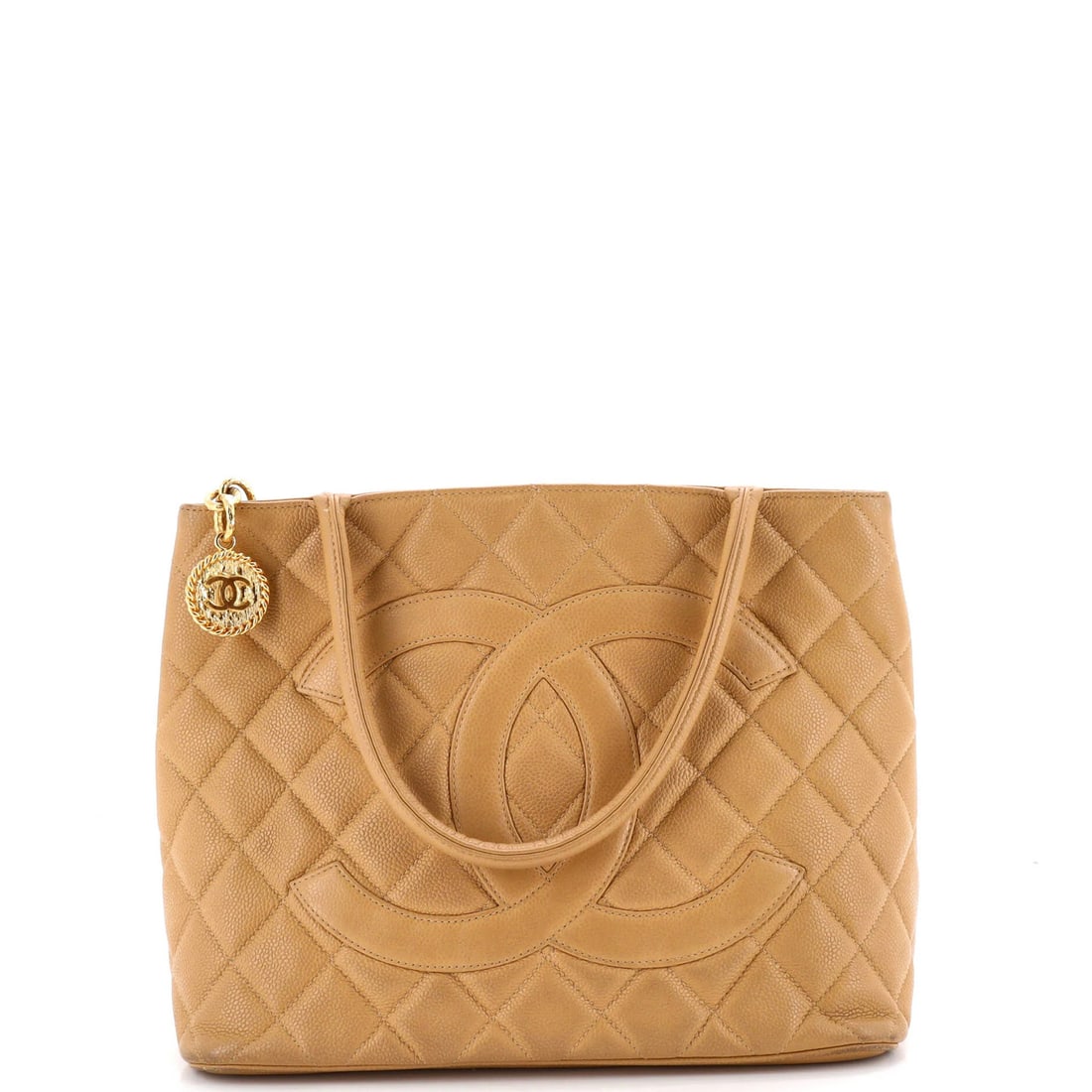 Caviar quilted tote by Chanel: Caviar quilted tote by Chanel Experience the timeless elegance of Chanel's iconic Medallion Tote, boasting a quilted Caviar exterior in neutral tones that exudes sophistication and refinement. With