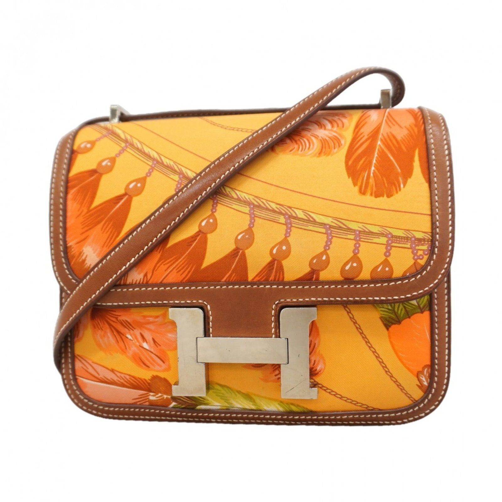 Hermes Silk Shoulder Bag: Hermes Silk Shoulder Bag A stunning Fauve silk shoulder bag from the iconic French brand Hermes, boasting sleek silver hardware and a timeless design that exudes elegance. With its compact size and lu