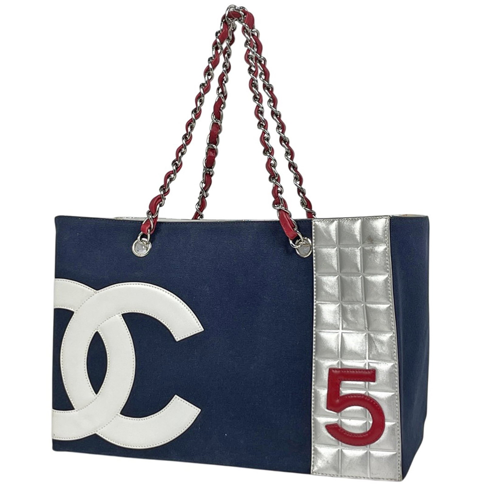 Chanel Tote Bag Canvas, Leather: Chanel Tote Bag Canvas, Leather A pre-owned Chanel tote bag in navy and silver, crafted from high-quality canvas and leather, offers a stylish and practical solution for daily errands or work trips.