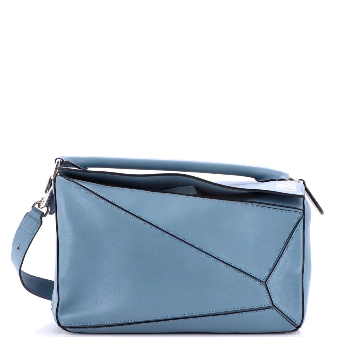 Loewe medium leather puzzle bag: Loewe medium leather puzzle bag The Loewe Puzzle Bag is a masterclass in understated luxury, with its sleek blue leather exterior and neutral canvas interior exuding effortless sophistication. With