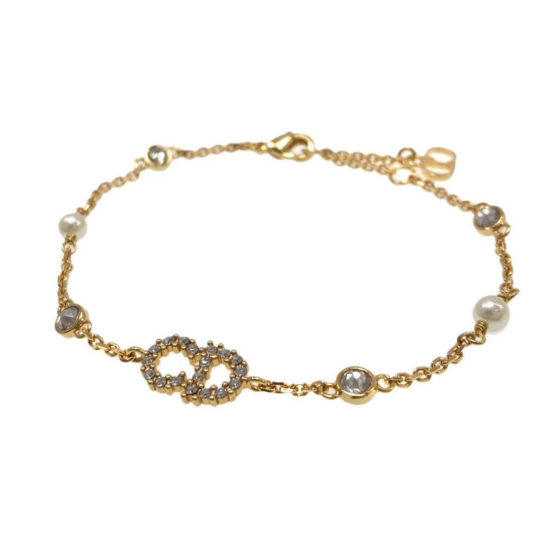 Christian Dior metal bracelet with faux pearls and rhinestones.: Christian Dior metal bracelet with faux pearls and rhinestones. Elevate your style with the iconic Christian Dior metal bracelet, adorned with luxurious faux pearls and sparkling rhinestones in