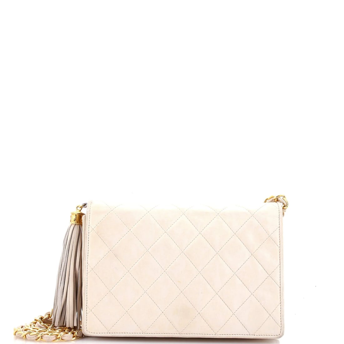 Chanel mini quilted lambskin vintage tassel flap bag: Chanel mini quilted lambskin vintage tassel flap bag A rare and coveted vintage Chanel mini quilted lambskin tassel flap bag, this stylish cross-body bag boasts iconic neutral leather exterior with