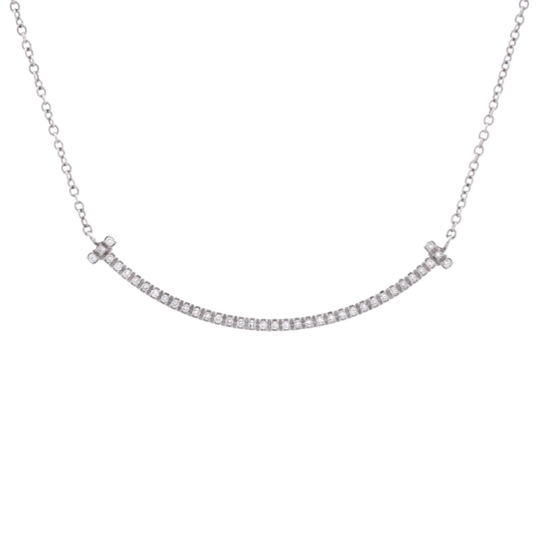 Tiffany & Co. 18K White Gold T Smile Pendant with Diamonds Necklace Small: Tiffany & Co. 18K White Gold T Smile Pendant with Diamonds Necklace Small Elevate your style with the timeless elegance of Tiffany & Co.'s 18K White Gold T Smile Pendant Necklace, adorned with a
