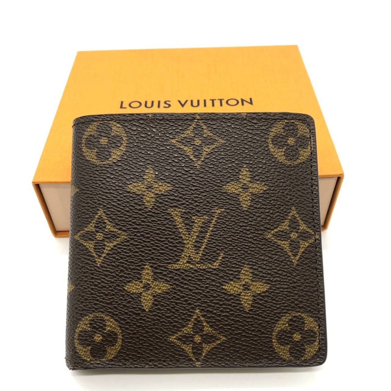 Louis Vuitton canvas wallet monogram bi-fold: Louis Vuitton canvas wallet monogram bi-fold A classic Louis Vuitton bi-fold wallet, this timeless piece boasts the iconic monogram canvas design in rich brown tones. With its sleek 10cm x 10cm size a