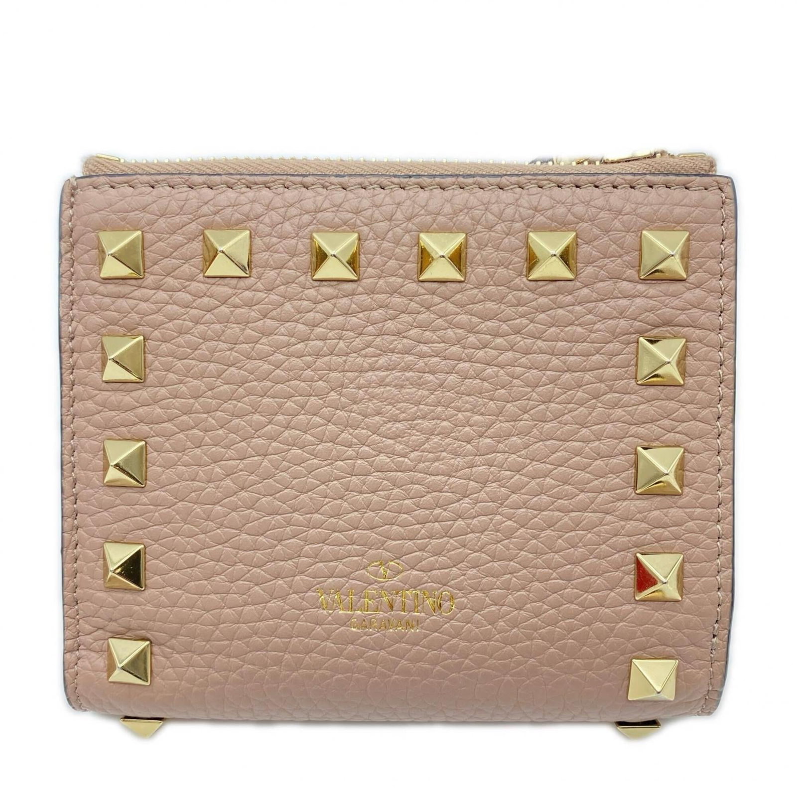 Valentino is a leather bi-fold wallet.: Valentino is a leather bi-fold wallet. A timeless piece from the iconic Italian brand, Valentino's leather bi-fold wallet boasts classic elegance with its understated beige hue and sleek design. With