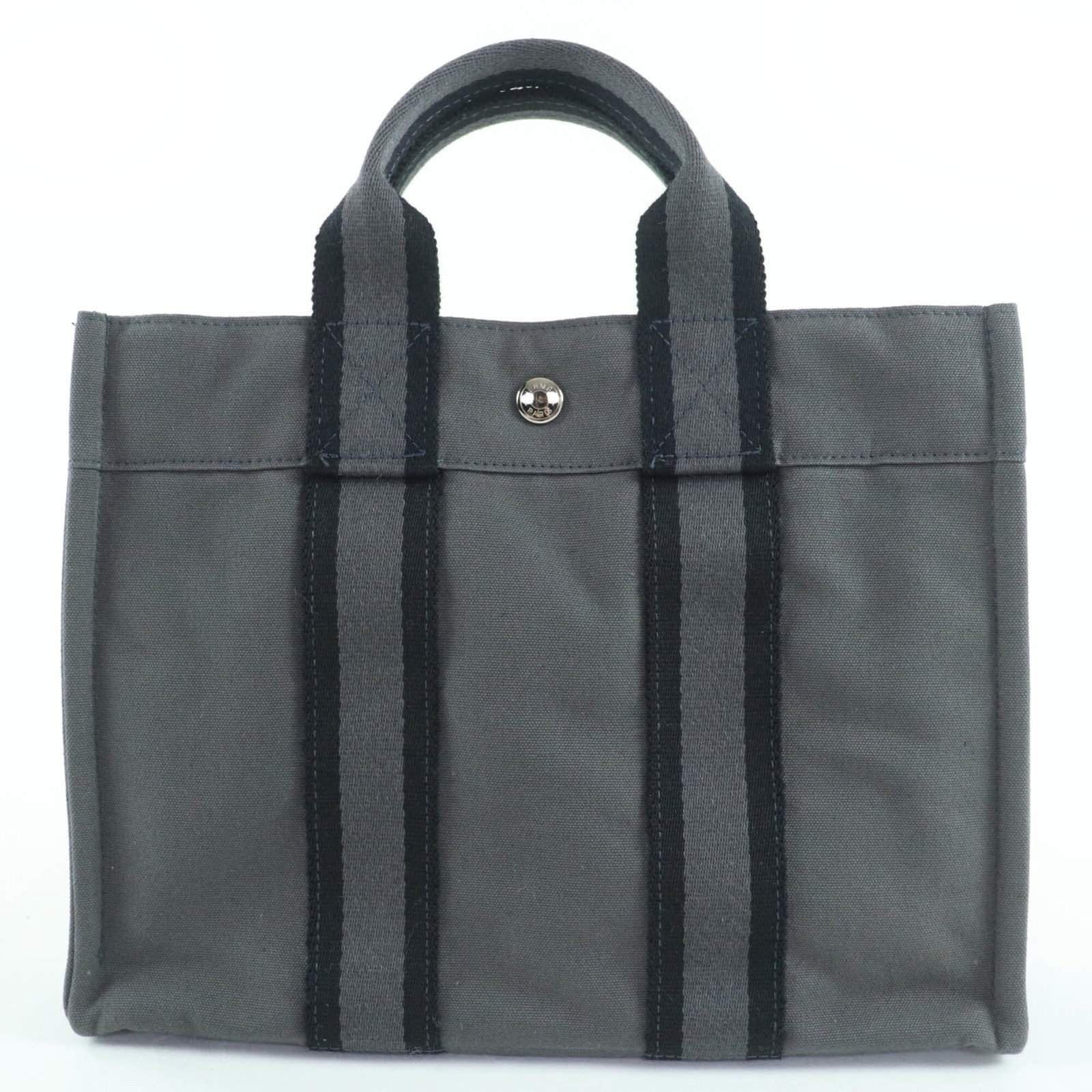 Hermes Handbag is a cotton tote bag: Hermes Handbag is a cotton tote bag A timeless and elegant gray cotton tote bag from the iconic French brand Hermes, boasting classic silver hardware and a sturdy 25cm handle for effortless carrying.