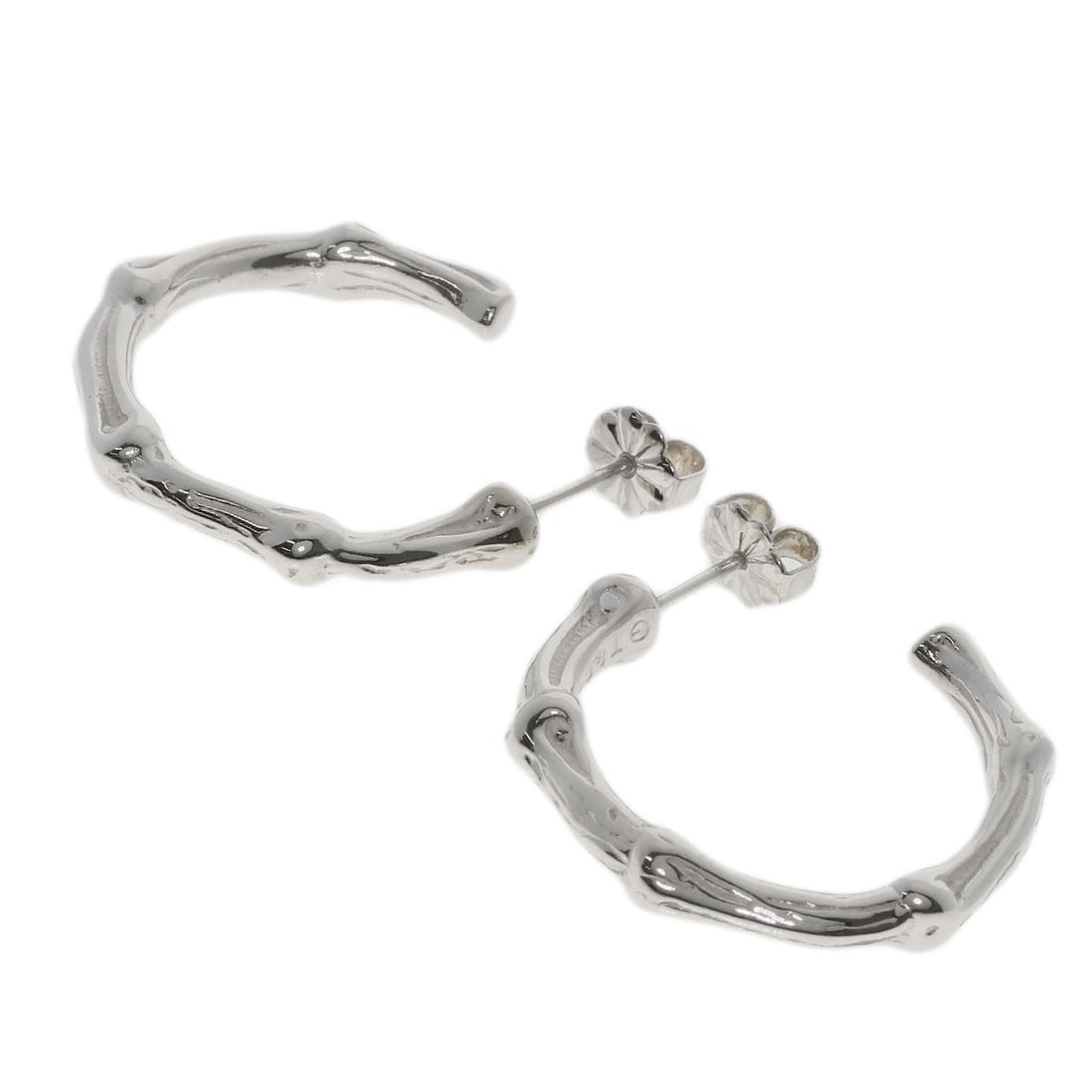 Tiffany Co. Silver Bamboo Earring: Tiffany Co. Silver Bamboo Earring Elevate your elegance with the Tiffany Co. Silver Bamboo earring, a stunning silver design that embodies understated sophistication. Crafted from high-quality silver