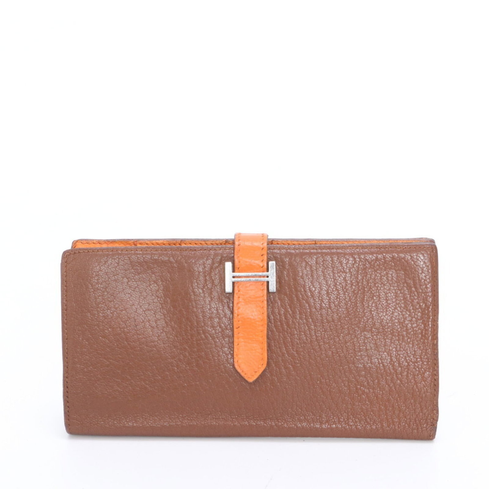 Hermes leather bi-fold wallet: Hermes leather bi-fold wallet A pre-owned Hermes leather bi-fold wallet in rich brown and vibrant orange hues, boasting the iconic brand's signature craftsmanship. With its classic long design and