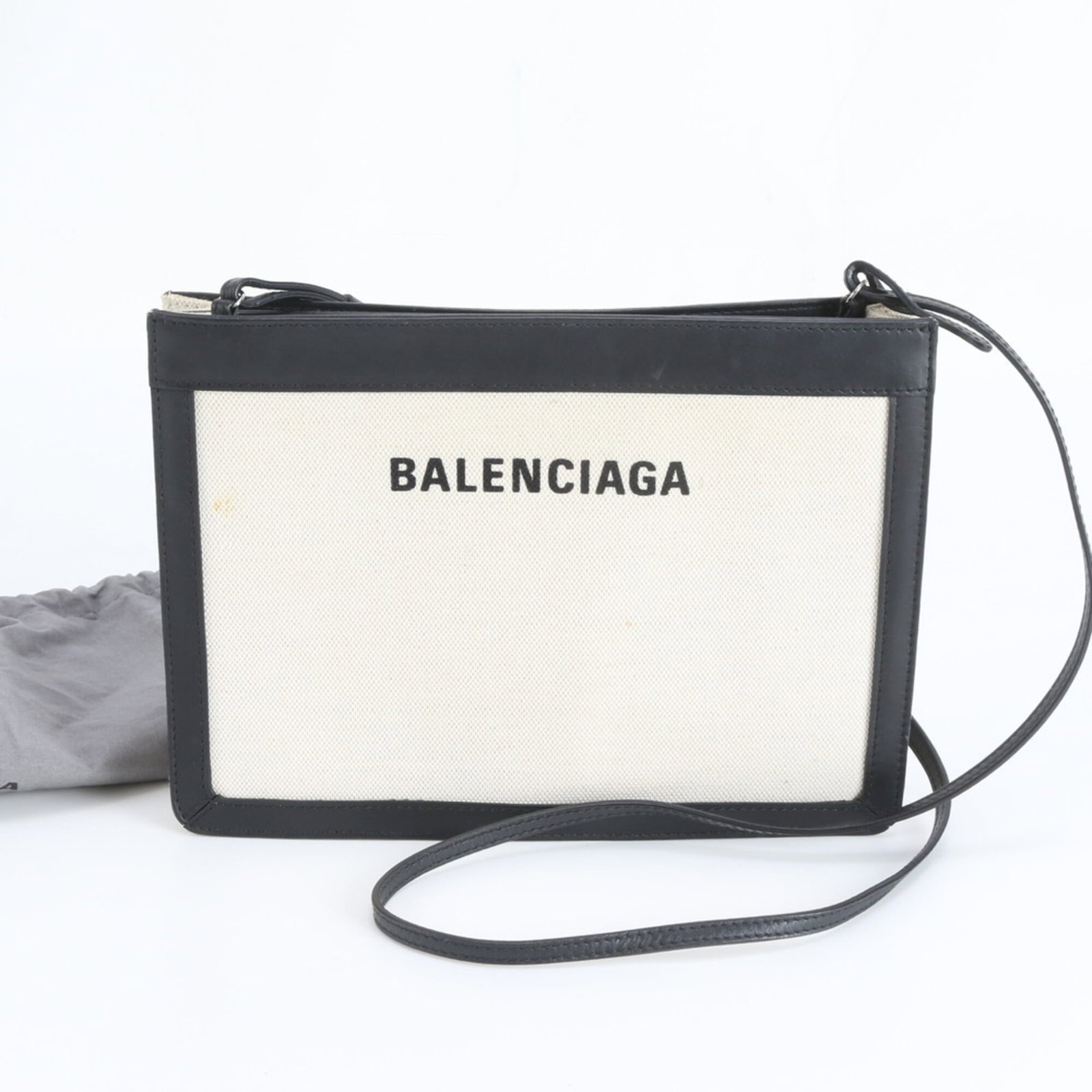 Leather canvas shoulder bag by Balenciaga: Leather canvas shoulder bag by Balenciaga A sleek and sophisticated Balenciaga pochette, crafted from luxurious leather and canvas, boasts a timeless design that exudes effortless chic. With its