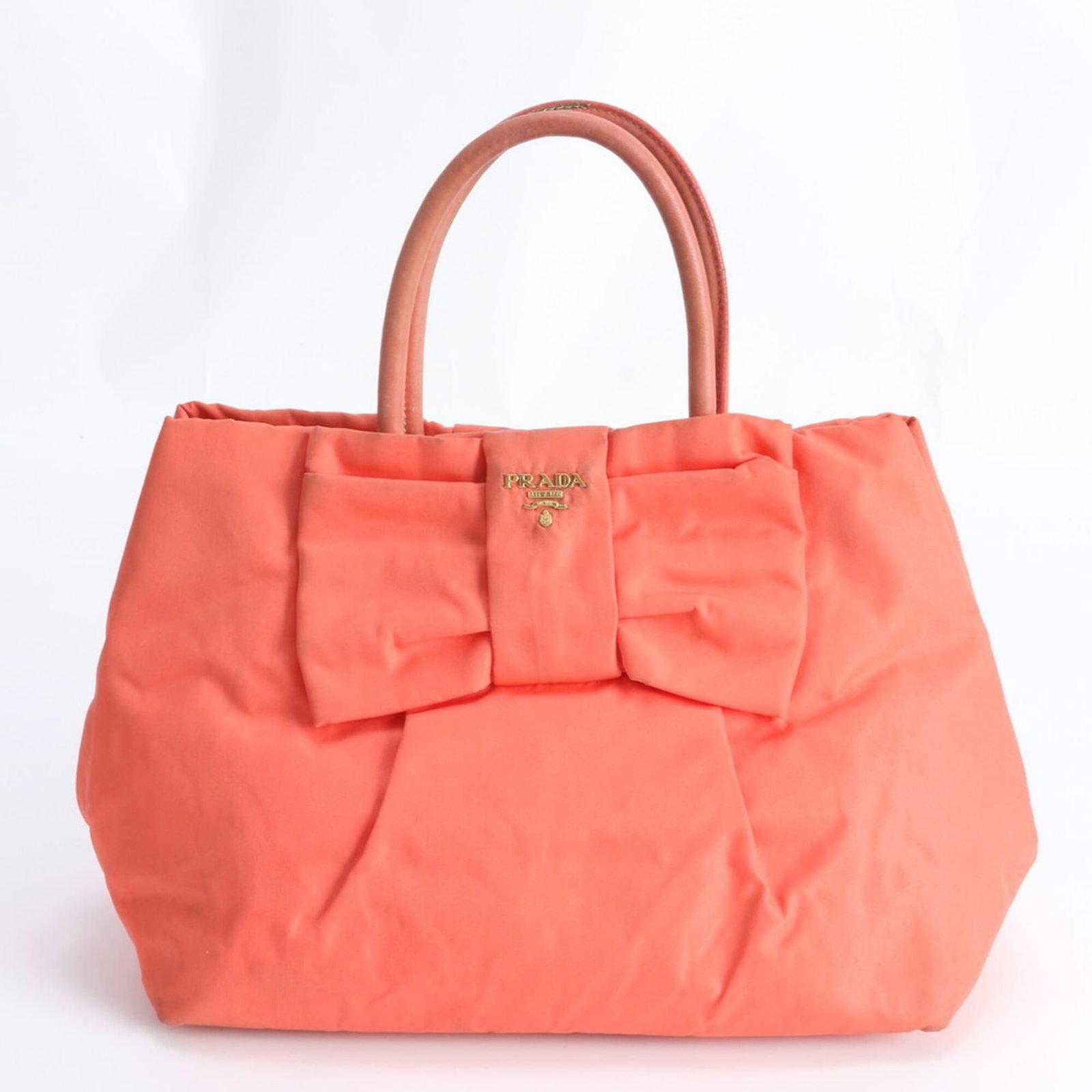 Prada Handbag Nylon Leather Tote: Prada Handbag Nylon Leather Tote A vibrant and stylish Prada tote in orange, crafted from a unique blend of nylon and leather, adds a pop of color to any outfit. With its spacious interior and