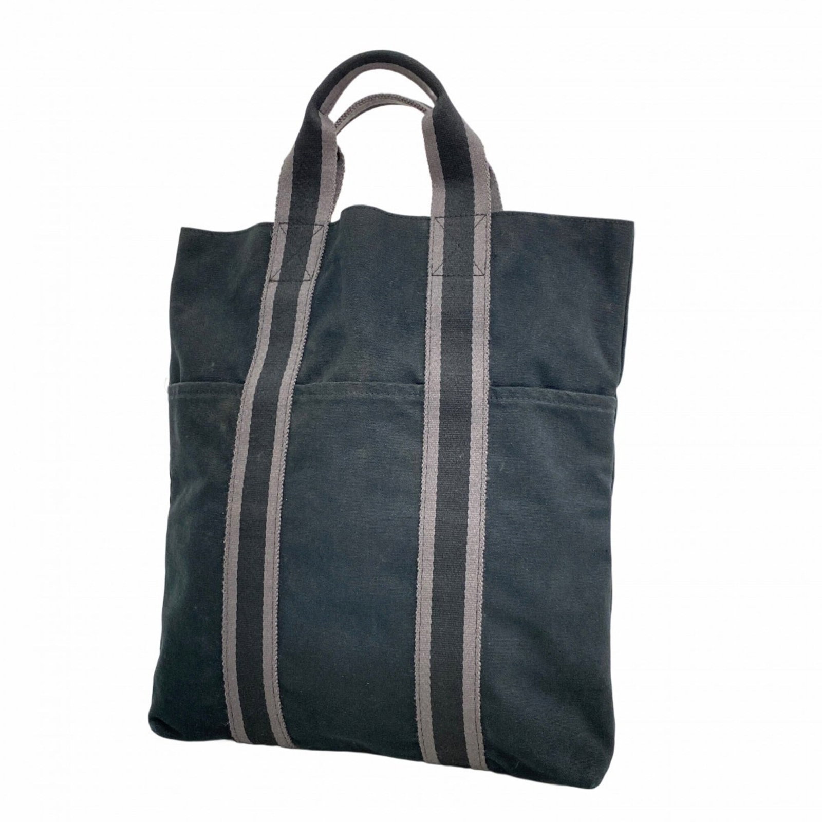 Hermes Tote Bag Canvas: Hermes Tote Bag Canvas A pre-owned Hermes tote bag in sleek black canvas, boasting the iconic brand's signature style and timeless design. With its classic 37cm x 31cm size and sturdy construction,