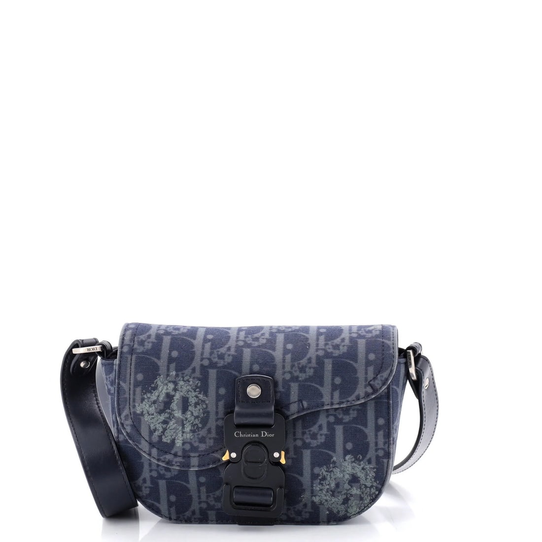 Christian Dior messenger bag with saddle buckle flap and printed oblique denim.: Christian Dior messenger bag with saddle buckle flap and printed oblique denim. Elevate your everyday with the iconic Christian Dior messenger bag, boasting a striking saddle buckle flap and printed