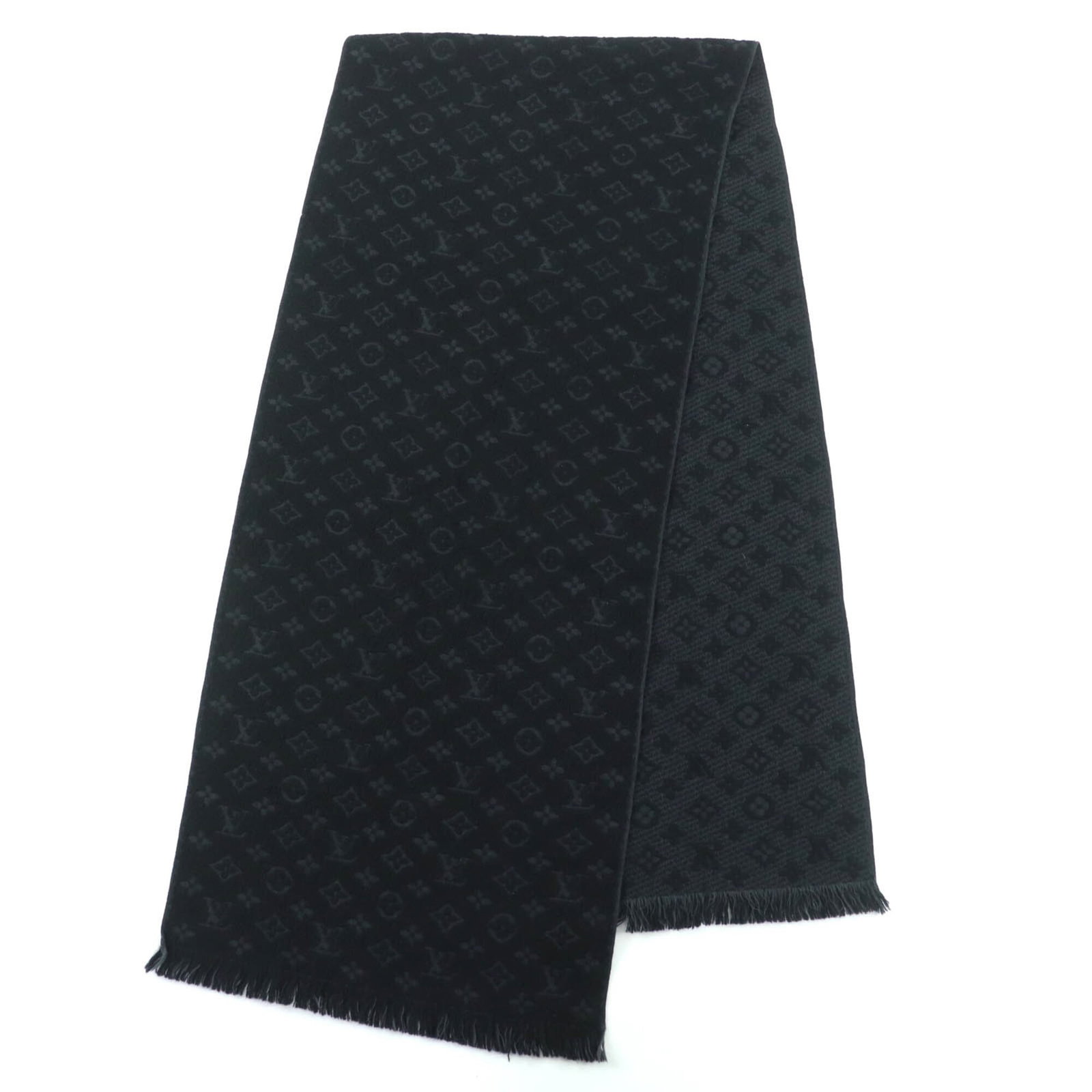Louis Vuitton Stole Wool 100%: Louis Vuitton Stole Wool 100% A luxurious Louis Vuitton stole made from 100% wool, crafted with impeccable attention to detail and boasting a sleek black finish that exudes sophistication. With its cl
