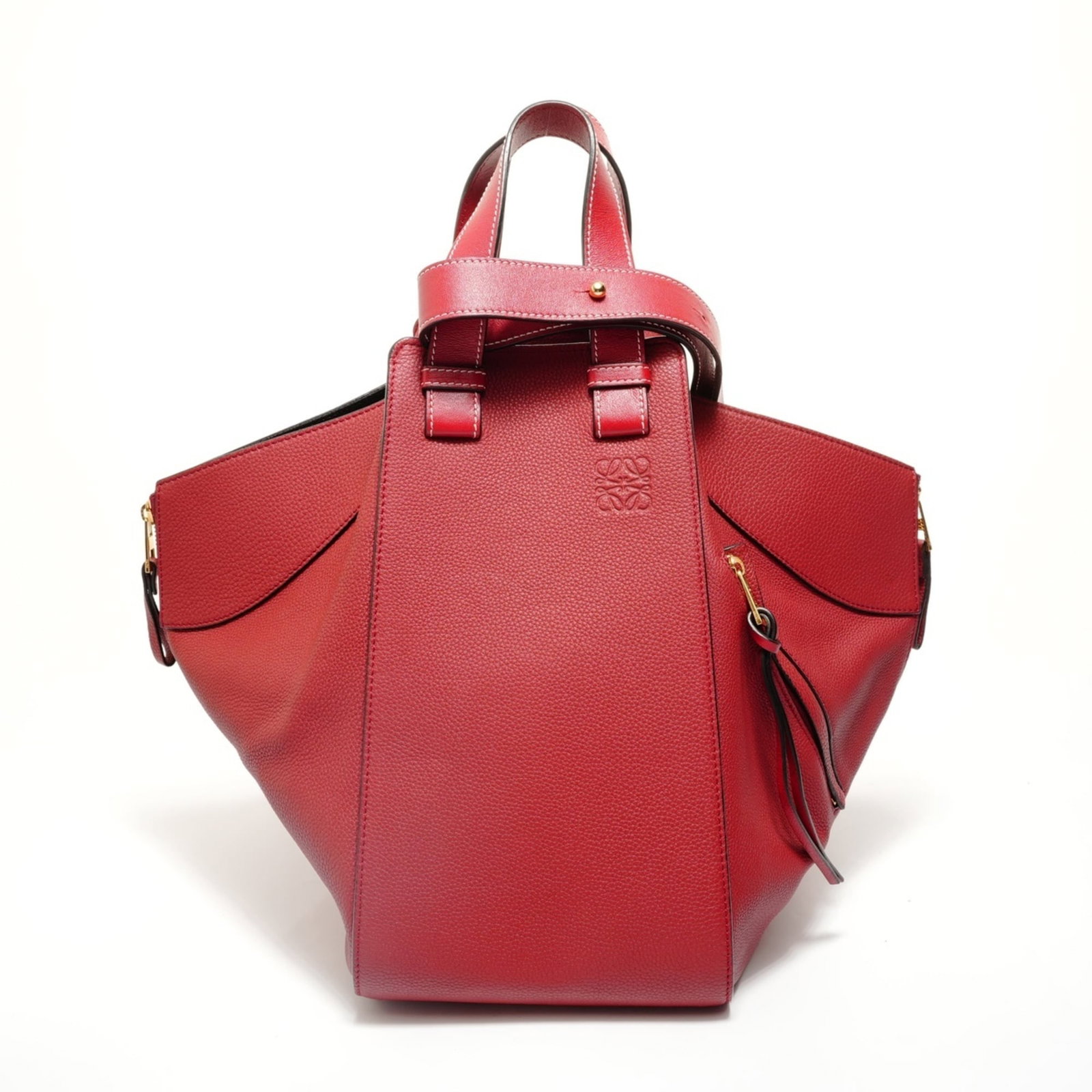 Leather Loewe Handbag: Leather Loewe Handbag A stunning red Loewe leather handbag, perfect for making a statement, boasts a classic design with clean lines and timeless elegance. With its spacious interior and adjustable