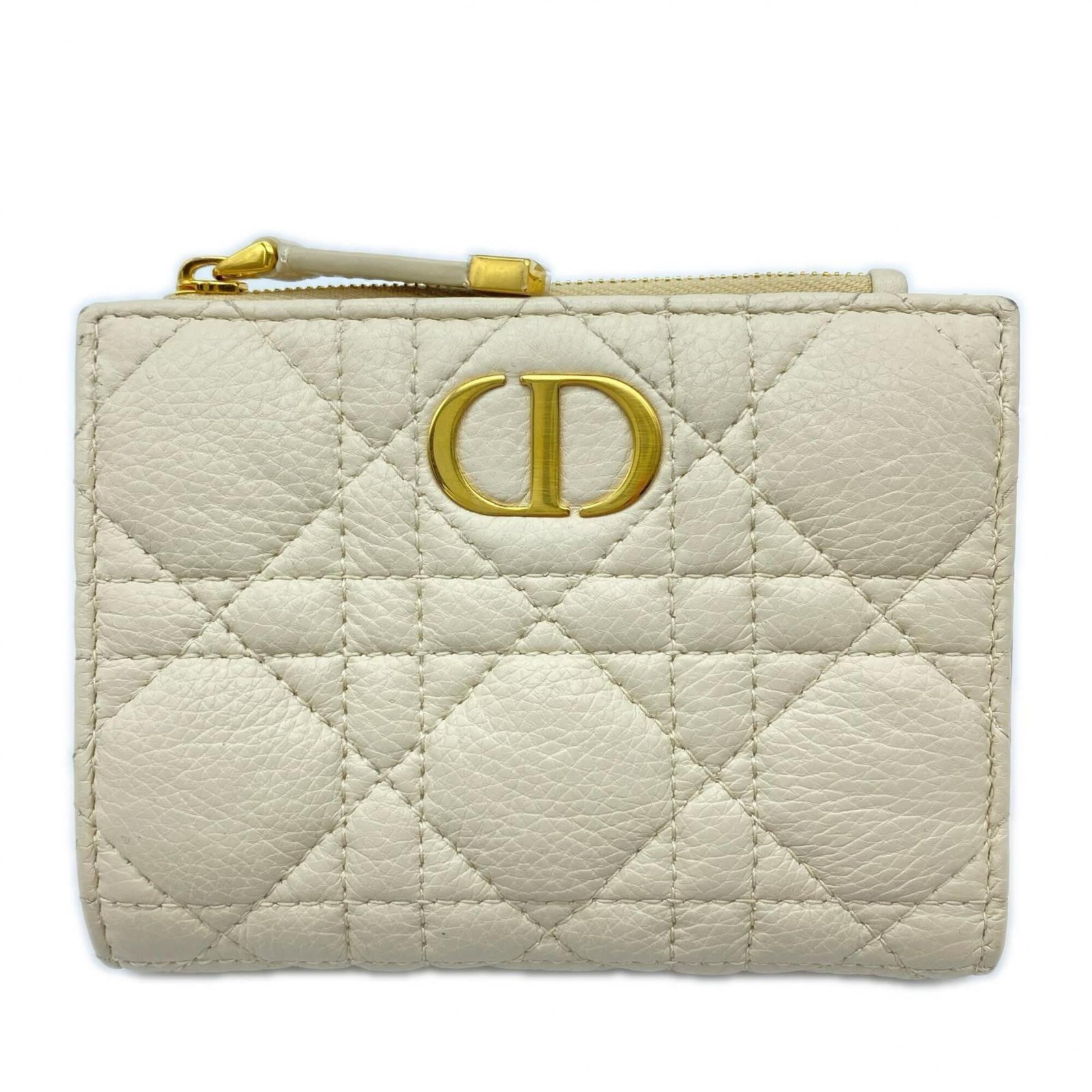 Christian Dior Bi Fold Leather Wallet: Christian Dior Bi Fold Leather Wallet A timeless piece from the iconic Christian Dior brand, this bi-fold leather wallet boasts classic elegance with its light beige calfskin exterior and