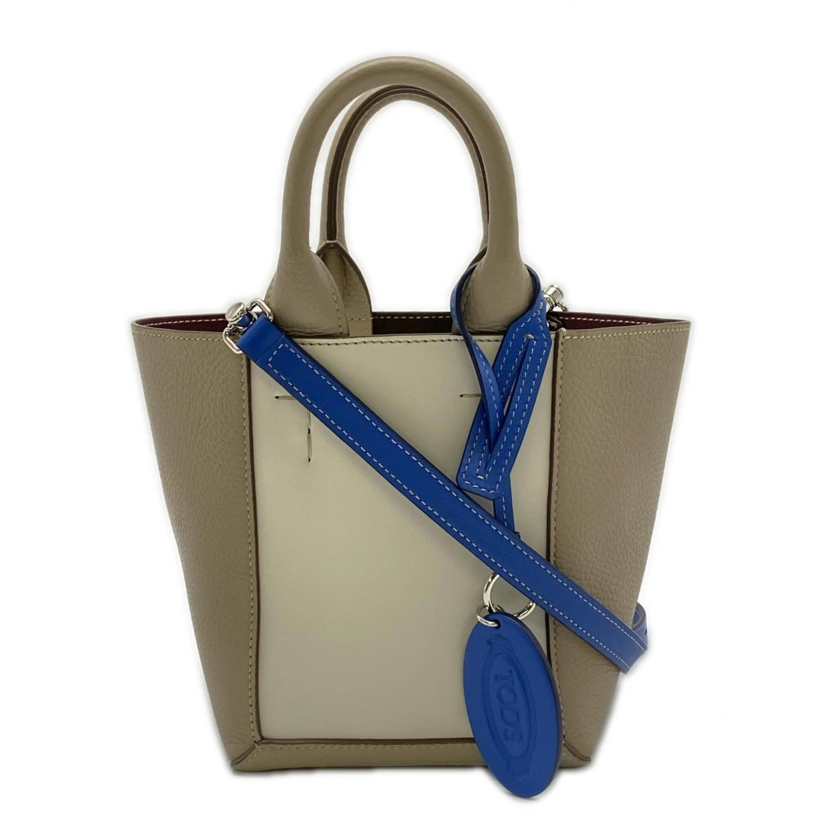 Tod's leather handbag: Tod's leather handbag "Elegant and sophisticated, this pre-owned Tod's leather handbag boasts a timeless beige and blue color combination that exudes refinement. With its classic design, sturdy 25cm