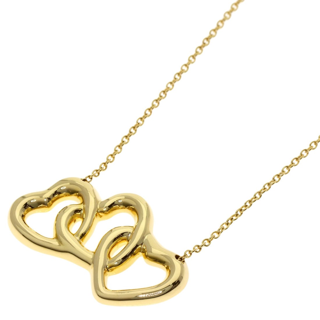 Tiffany Co triple heart necklace in yellow gold: Tiffany Co triple heart necklace in yellow gold Elevate your style with the timeless elegance of Tiffany & Co.'s triple heart necklace in 18k yellow gold. This exquisite piece showcases the iconic