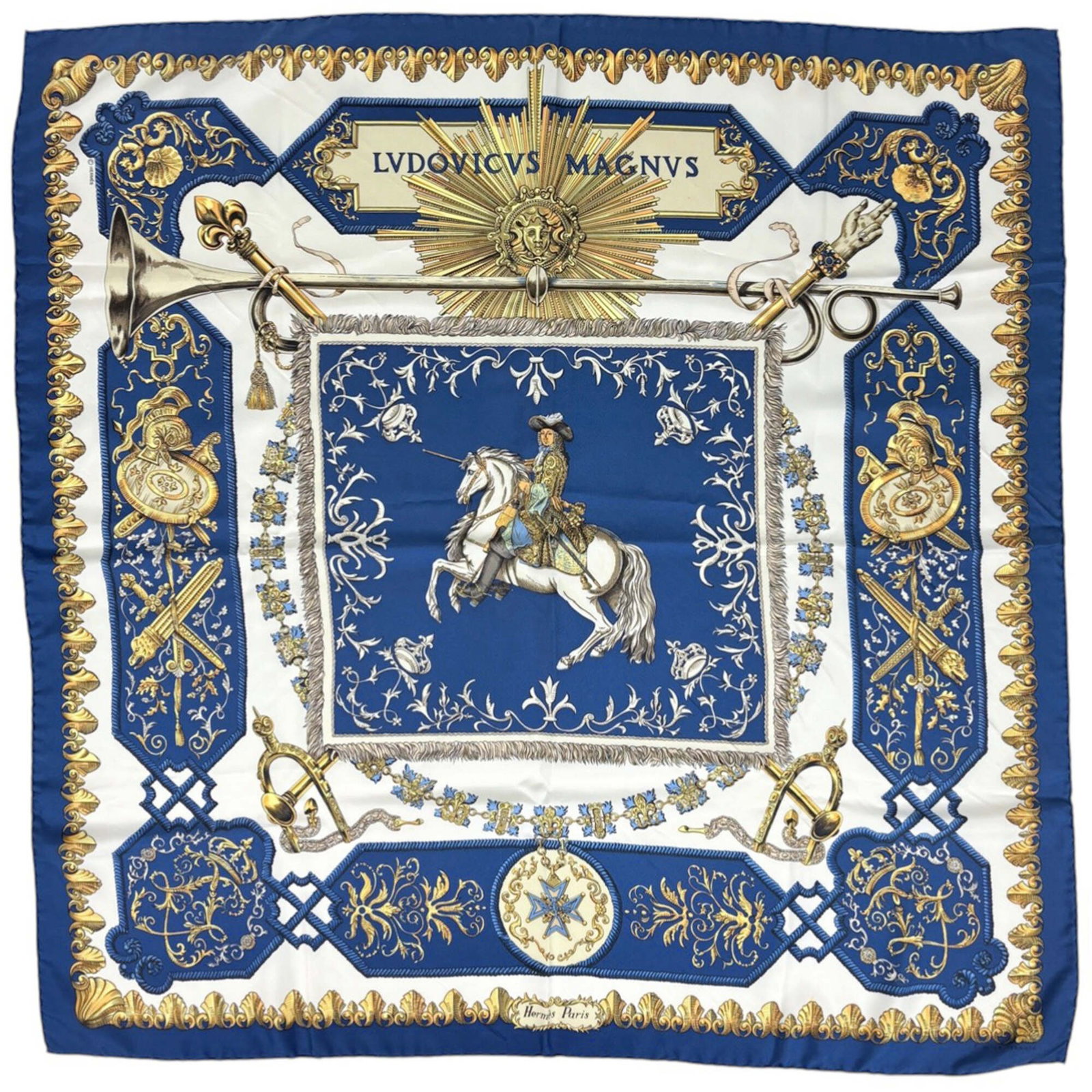 Hermes silk scarf: Hermes silk scarf A pre-owned Hermes silk scarf in stunning blue and multi-color hues, with intricate white accents, adds a touch of timeless elegance to any outfit. Made from luxurious silk, this
