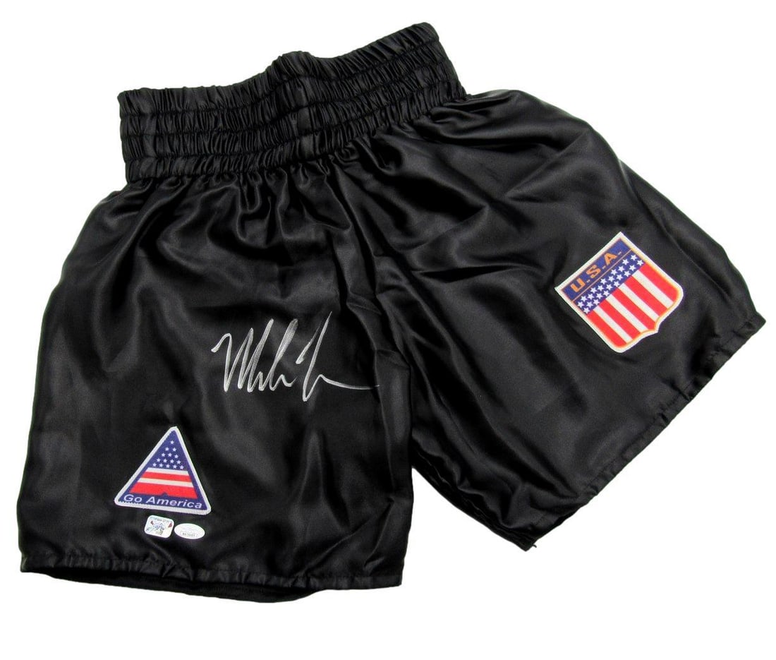 Mike Tyson Signed/ Autographed Black USA Go America Boxing Trunks JSA 190479: Mike Tyson Signed/ Autographed Black USA Go America Boxing Trunks JSA 190479 Own a piece of boxing history with these authentic Mike Tyson signed black USA Go America Boxing Trunks, certified by the J
