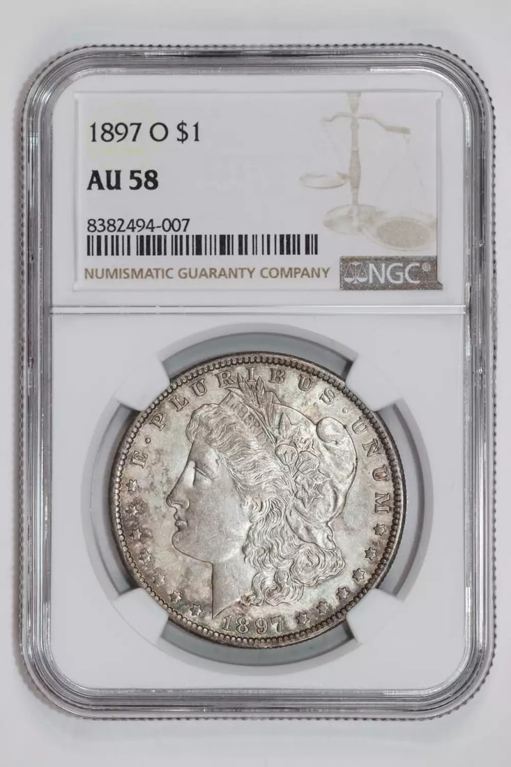 1897-O MORGAN DOLLAR NGC AU58 ORIGINAL PQ SLIDER: 1897-O MORGAN DOLLAR NGC AU58 ORIGINAL PQ SLIDER Experience the charm of the 1897-O Morgan Dollar, one of the most iconic coins in American history. With its rich silver composition and NGC certificat
