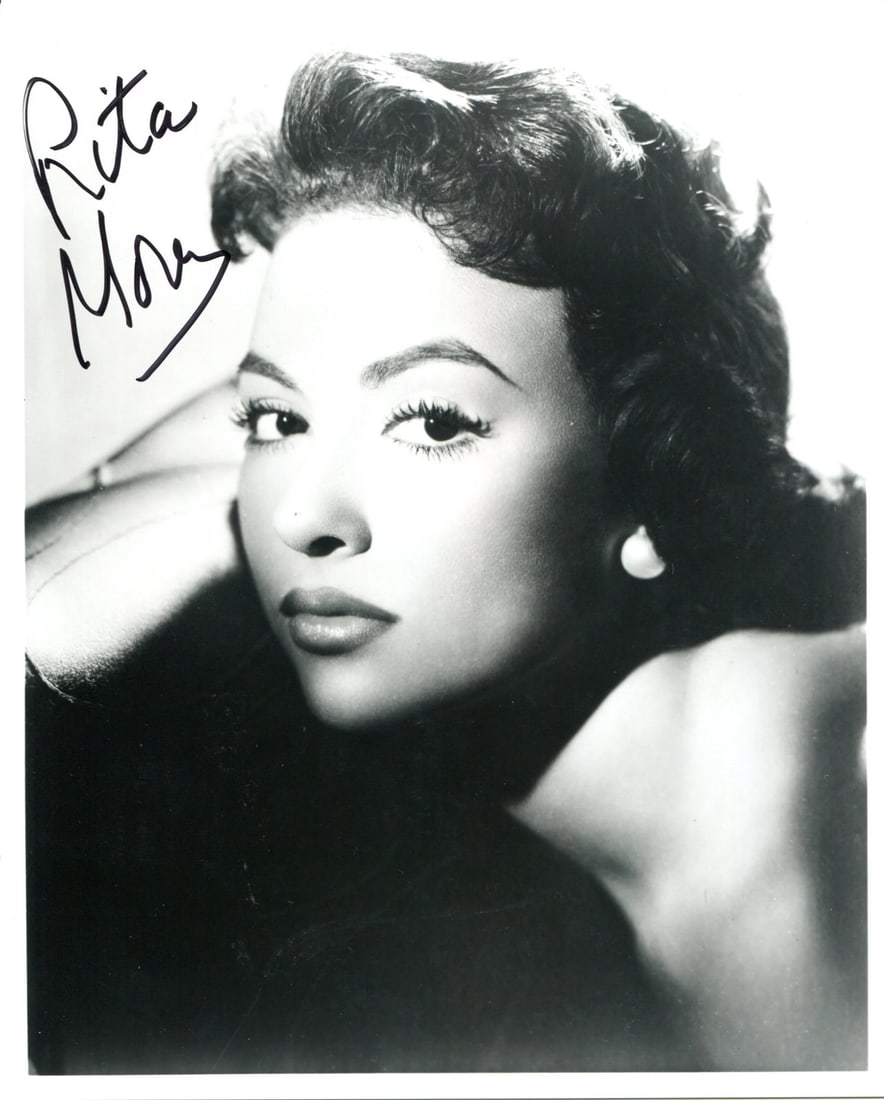Rita Moreno Autographed 8x10 Photo: Rita Moreno Autographed 8x10 Photo Meet the incomparable Rita Moreno, captured in a stunning 8x10 photo signed in black sharpie by the legendary actress herself. Authenticated by Rich Altman and accom