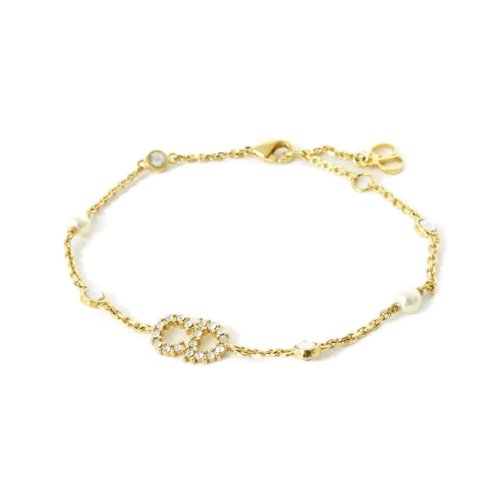 Christian Dior is a charm bracelet.: Christian Dior is a charm bracelet. A delicate charm bracelet from Christian Dior, featuring clear and white charms that add a touch of elegance to any outfit. With its 18cm length, this versatile acc