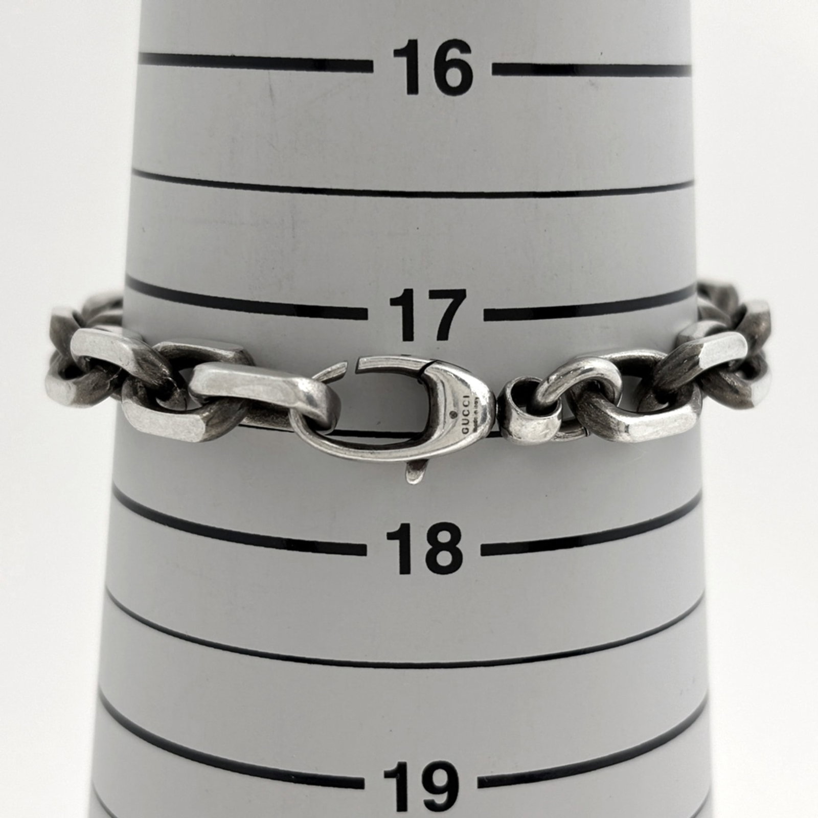 Gucci is a silver charm bracelet - 5