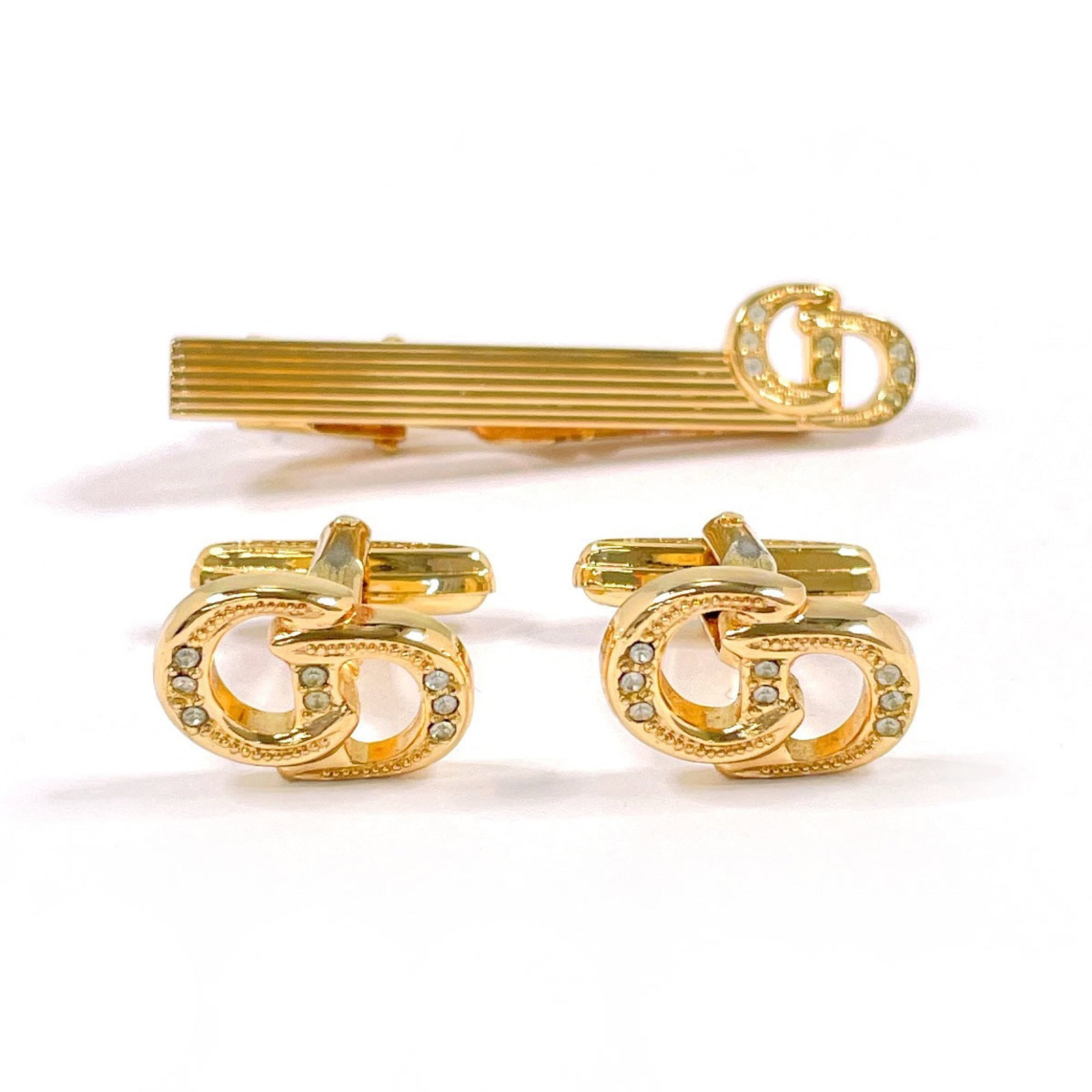 Christian Dior Metal Cufflinks: Christian Dior Metal Cufflinks Elevate your style with these luxurious Christian Dior metal cufflinks, crafted from gold and adorned with a subtle color stone accent. With their sleek design and