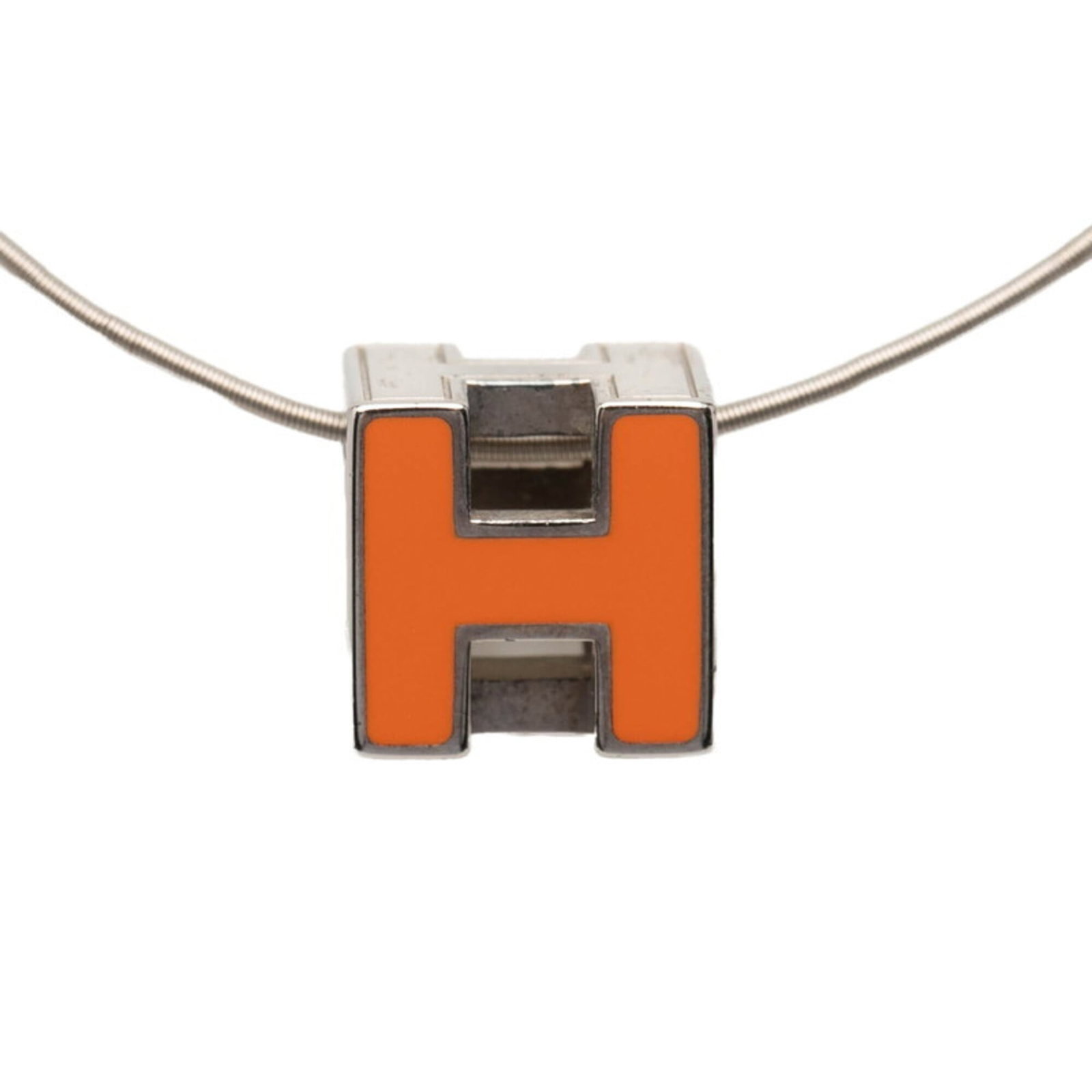 Hermes Silver Women's Orange Metal Cage d'H Cube Necklace: Hermes Silver Women's Orange Metal Cage d'H Cube Necklace A vibrant orange metal cage d'H cube necklace from Hermes adds a pop of color to any outfit. This silver-toned piece features an 11.8mm x 11.8